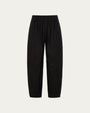Aella Mid Rise Relaxed Tapered Pants (black) on ghost mannequin, front view showing waist and tapered leg.