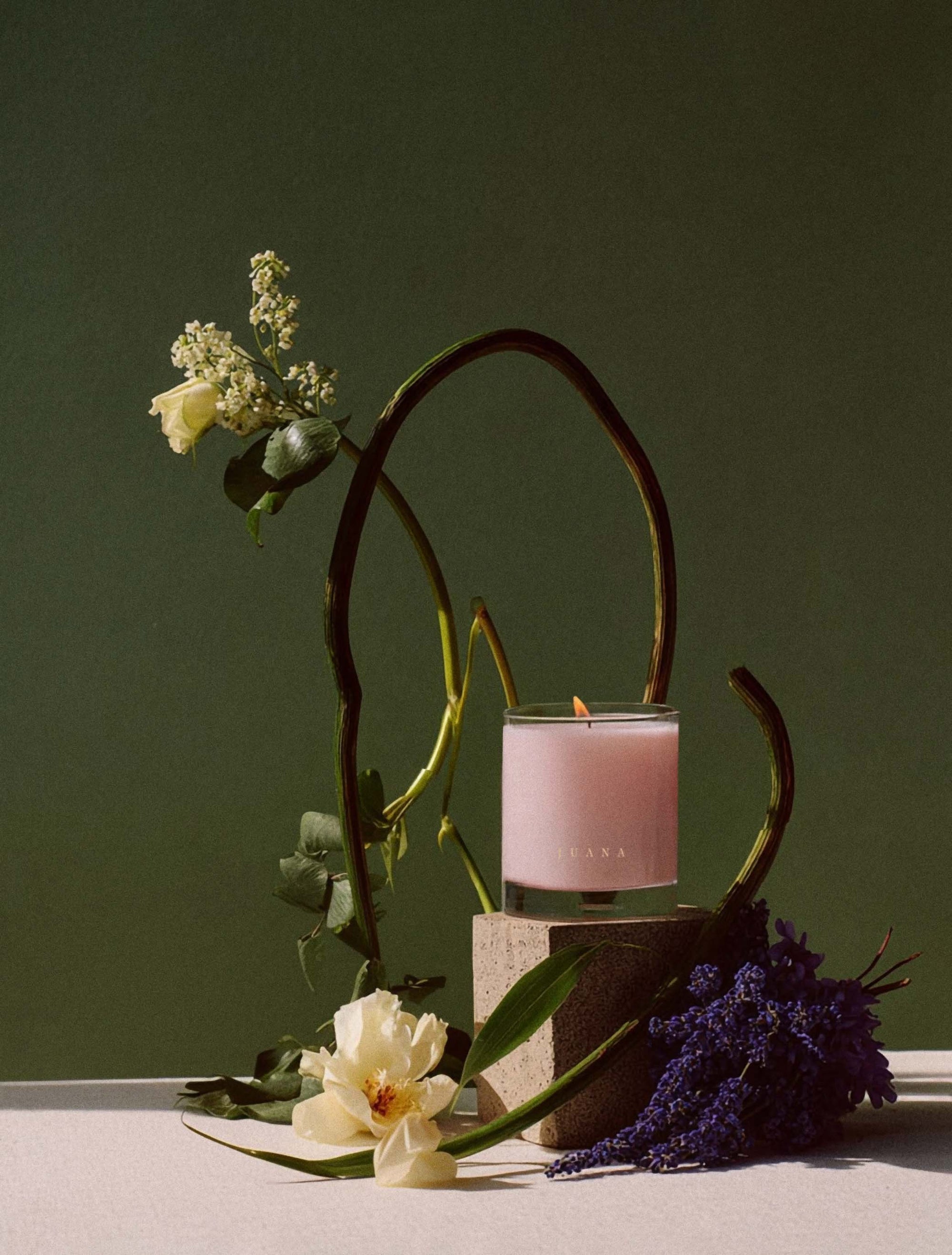 Juana Rose+Jasmine Romance Arouse apothecary medium candles next to flower in vase, vegan, eco-friendly.