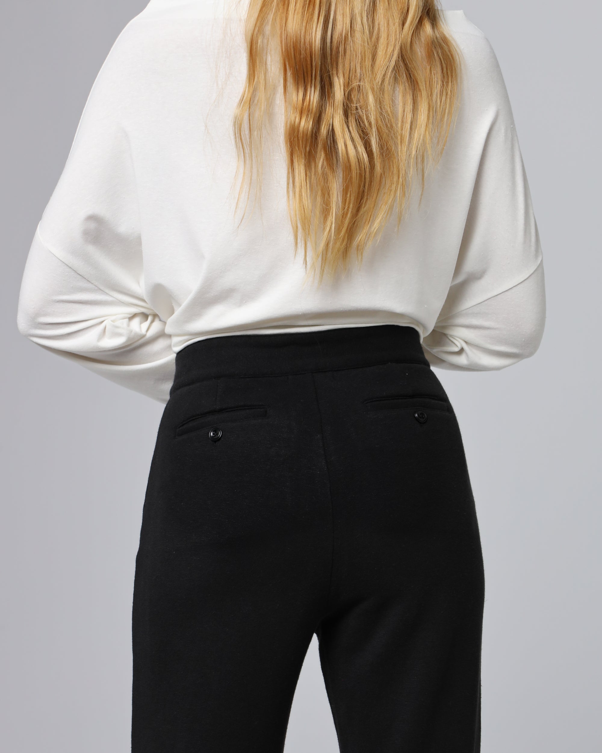 Detail shot of biodegradable corozo button and waistband on Classic Low Rise Straight Leg Pants (black).