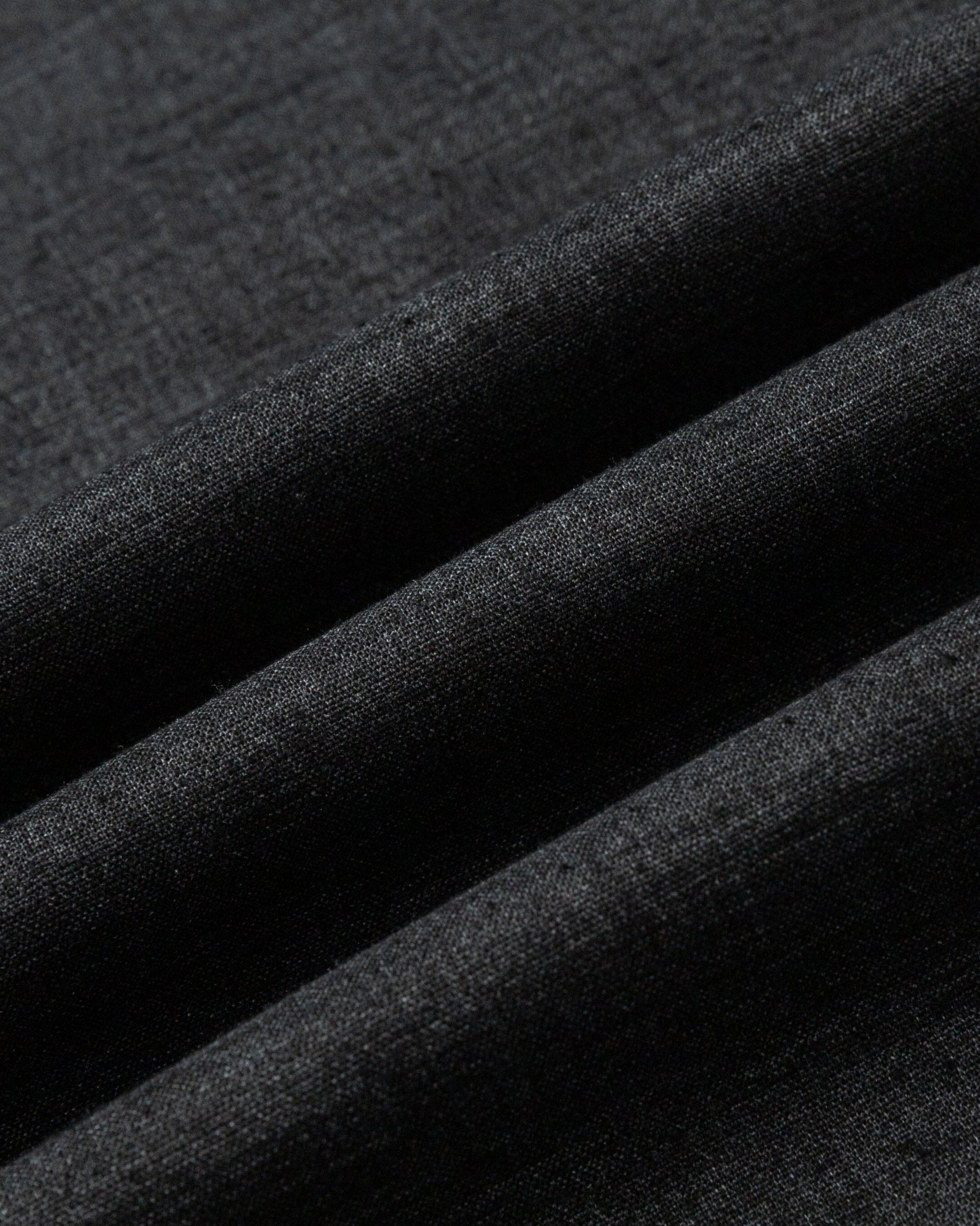 Close-up of hemp blend stretch twill fabric of the maxi skirt (black), highlighting breathable weave and subtle sheen.