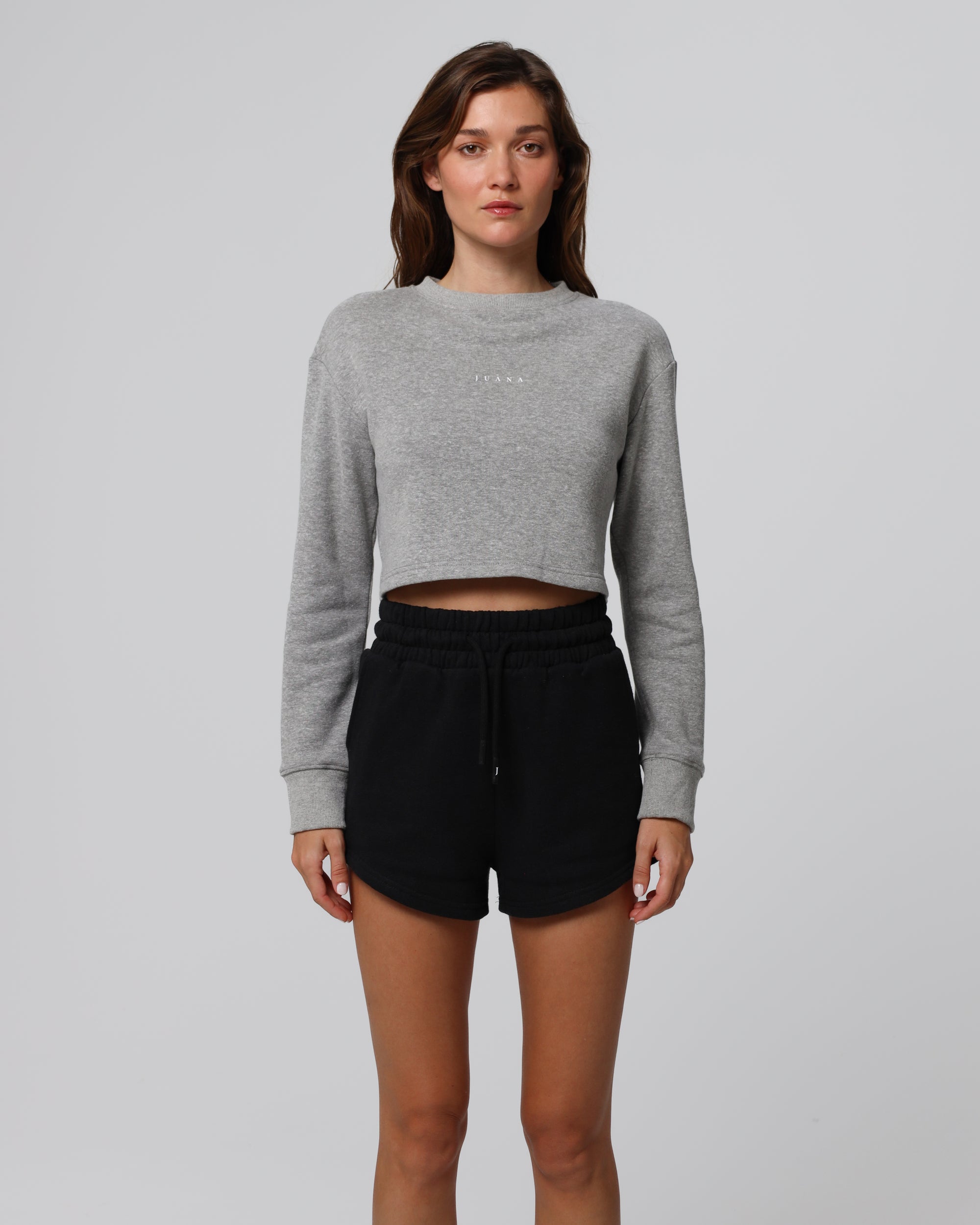 Model styling Fleece Shorts (black) with the Fleece Cropped Sweater for a coordinated set.