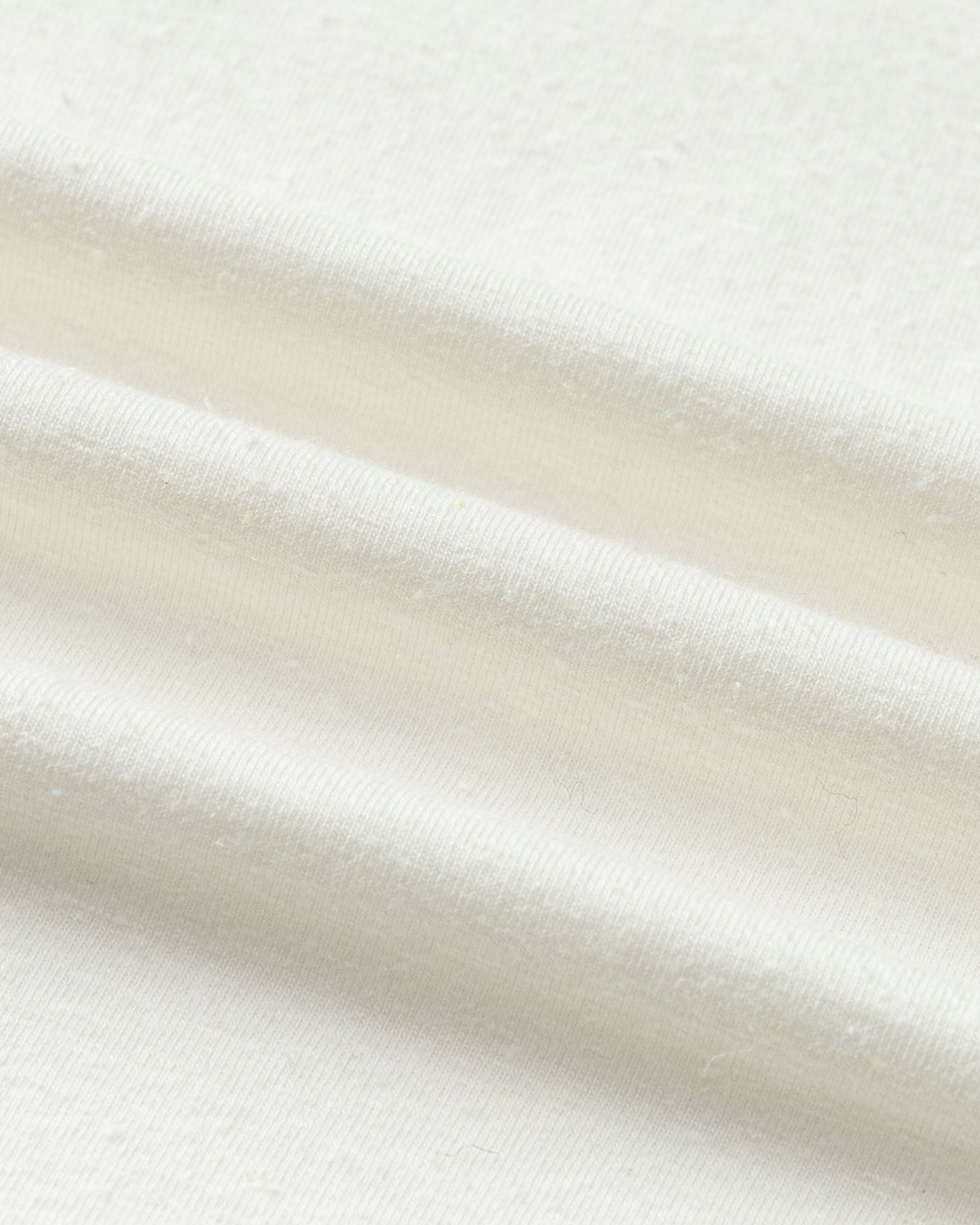 Close-up of hemp–Tencel™ knit of Off The Shoulder Top (white), highlighting breathable texture.