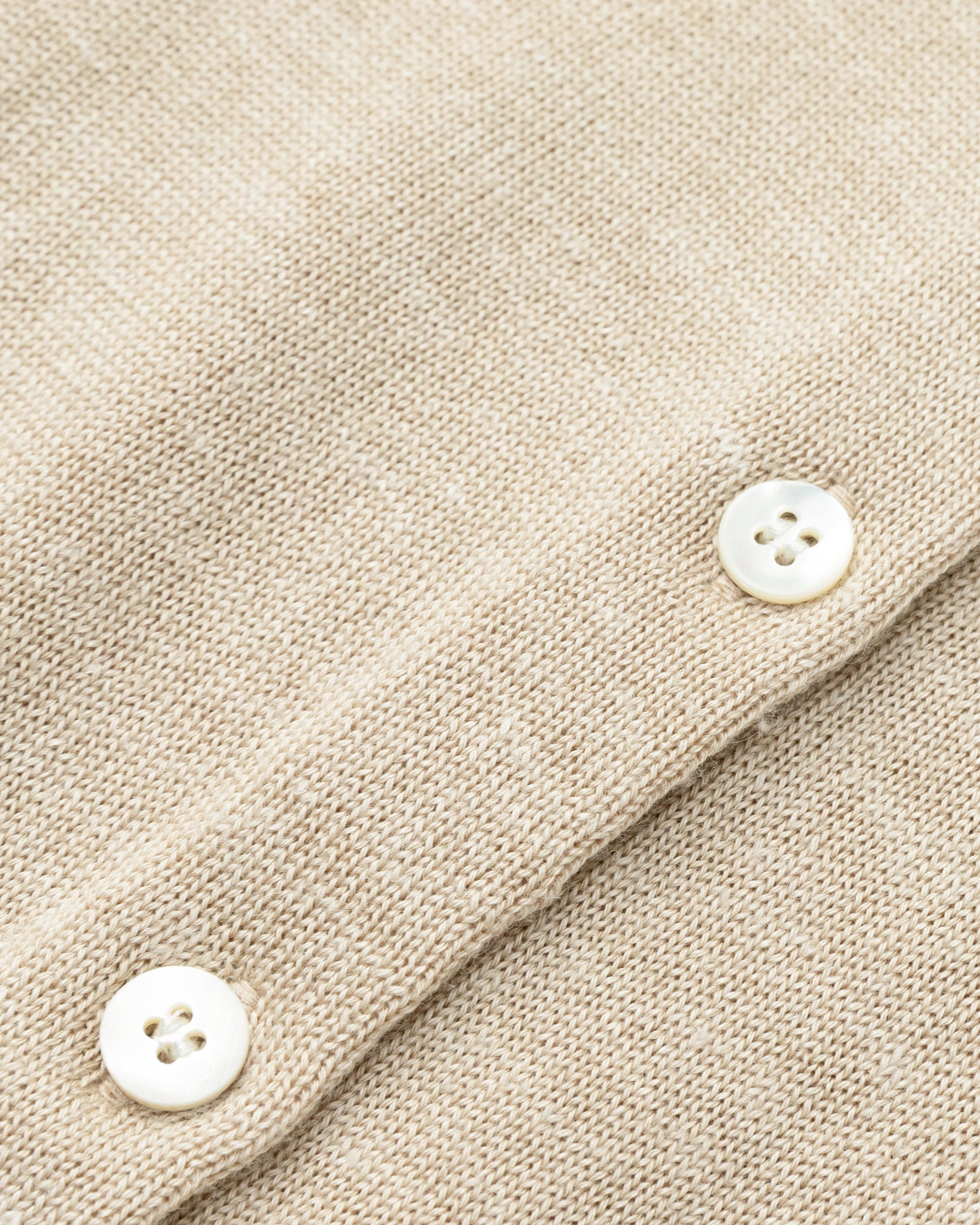 Flat lay of Liora Knitted Hemp Cardigan (beige), showing knit structure and finishing.