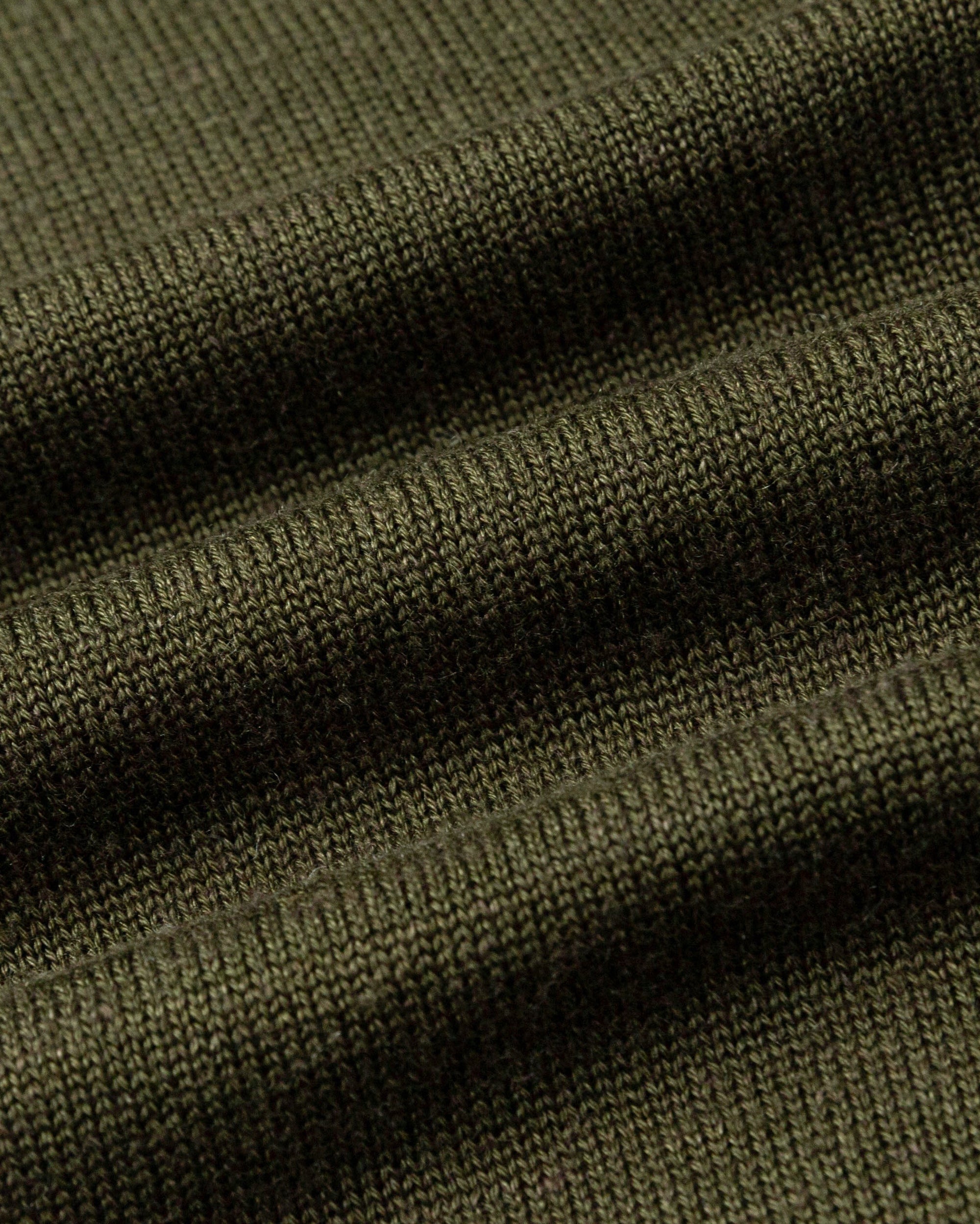 Close-up of merino–silk–hemp knit of Liora Cardigan (camo green), highlighting breathable softness and subtle sheen.