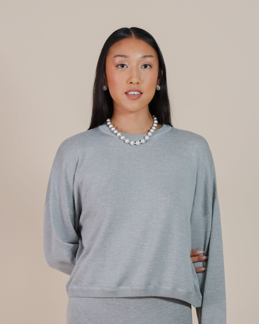 Model styling Juana Nilo Knitted Hemp Crewneck sweater with Nilo Knitted Hemp Pull-on Pants completing a a relaxed, cozy, and eco-friendly outfit.