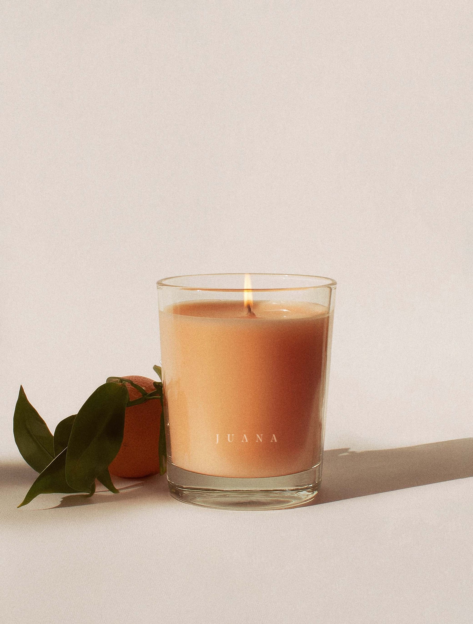 Juana Bergamot + Sativa Uplift apothecary candle in jar with minimal prop, vegan coco-apricot wax, non-toxic and eco-friendly.