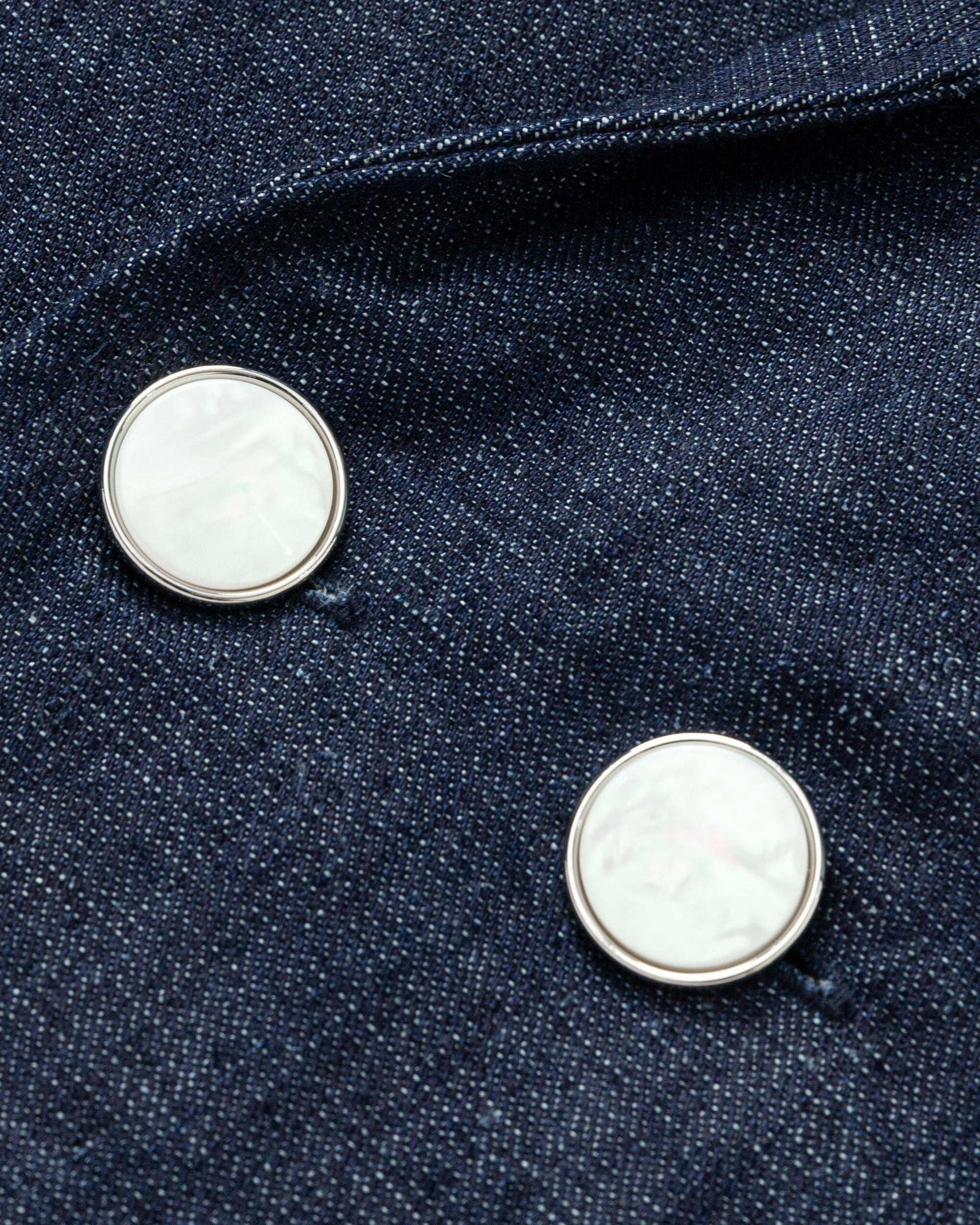 Textile close-up of Juana Denim Atelier Trench Coat, showing the hemp-cotton denim weave and rich indigo finish.