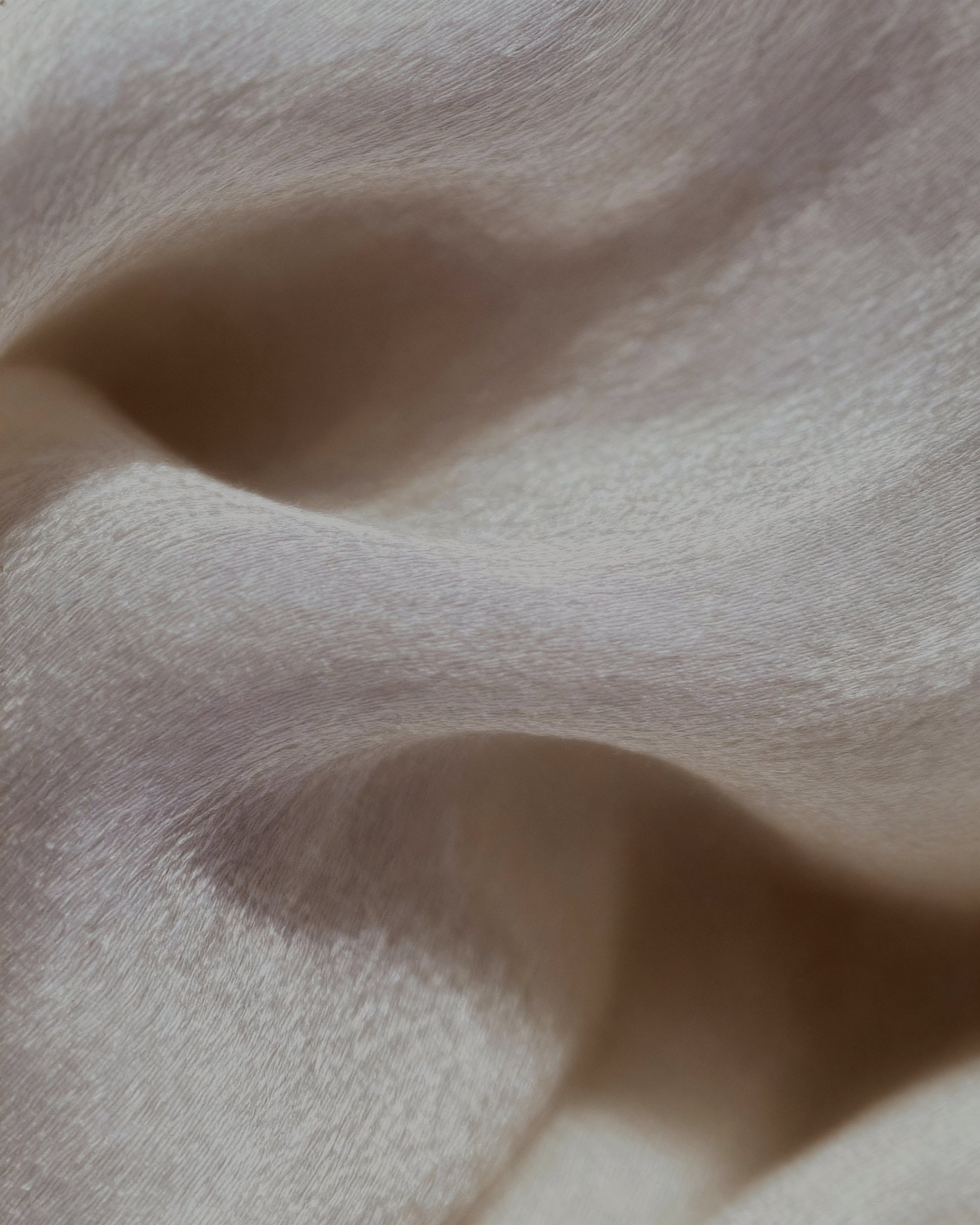 Close-up of soft, light-colored lyocell fabric texture