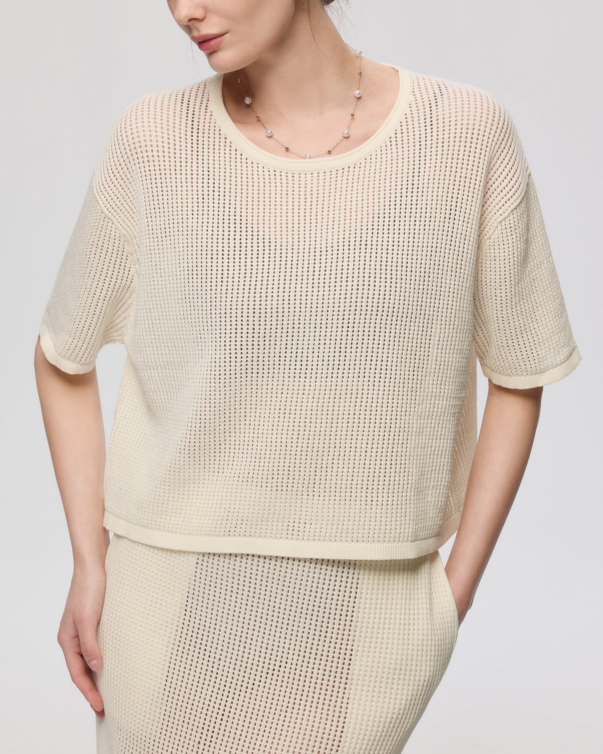 Juana Marina Crochet Tee Cream (sustainable cotton–hemp) detail view showing crochet stitch and crewneck finishing