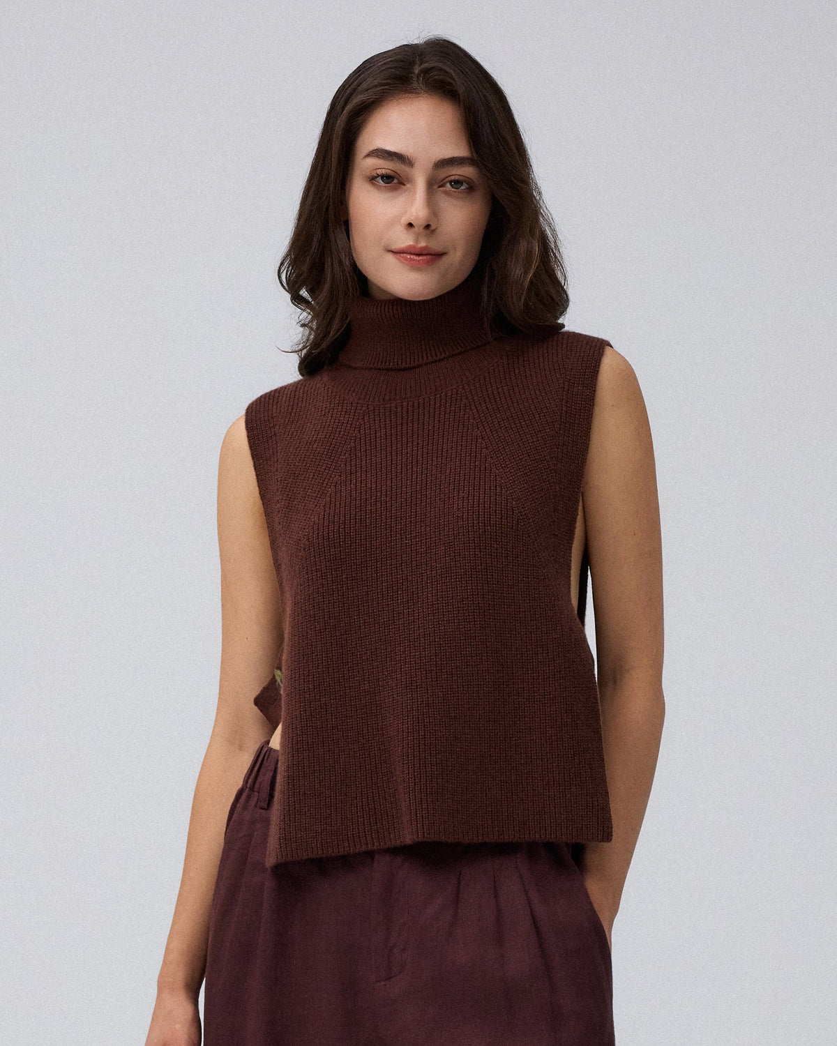 Juana Wool Cashmere Sweater Vest in Chocolate (wool–cashmere) styled over a lightweight shirt with the shell side straps visible.