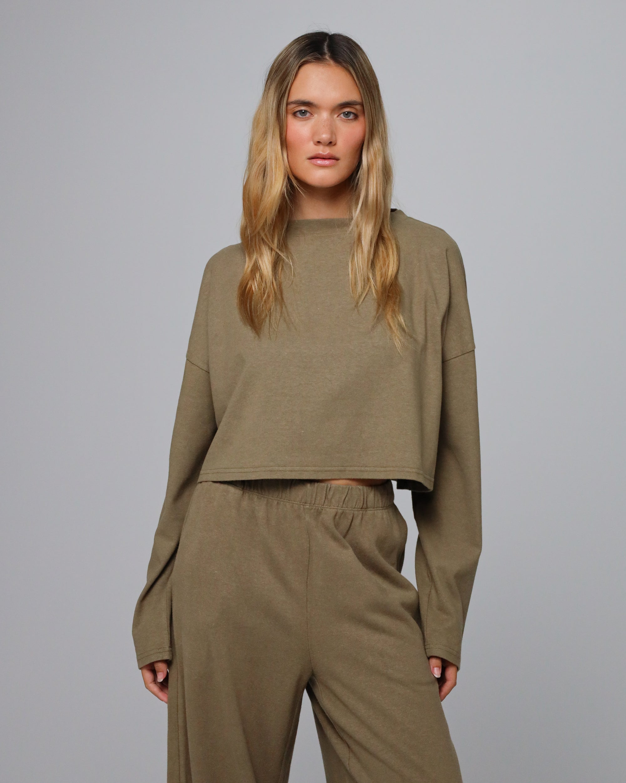 Woman wearing Juana Aera Boxy Sweater in hemp and organic cotton blend, styled for sustainable everyday wear.