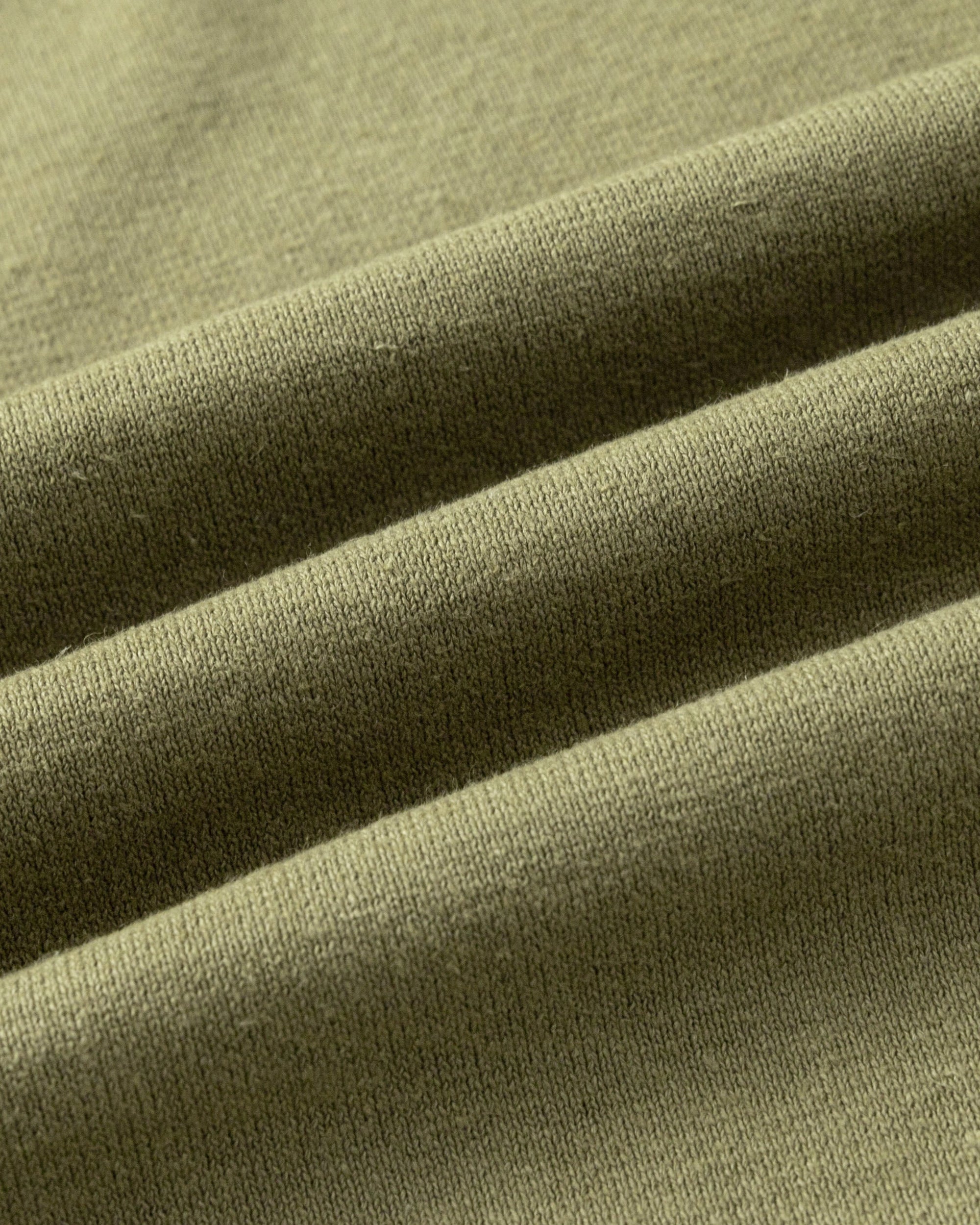 Close-up of hemp-organic cotton knit fabric of Aera Boxy Sweater, highlighting texture.