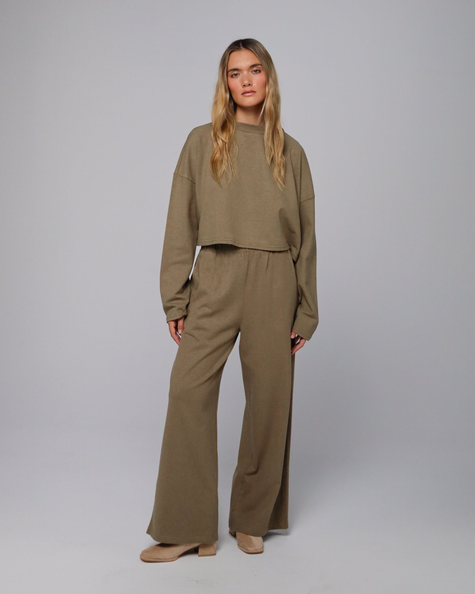 Woman wearing Juana Aera Pull-On Pants in a hemp–organic cotton blend with a wide-leg silhouette, styled for sustainable everyday wear.