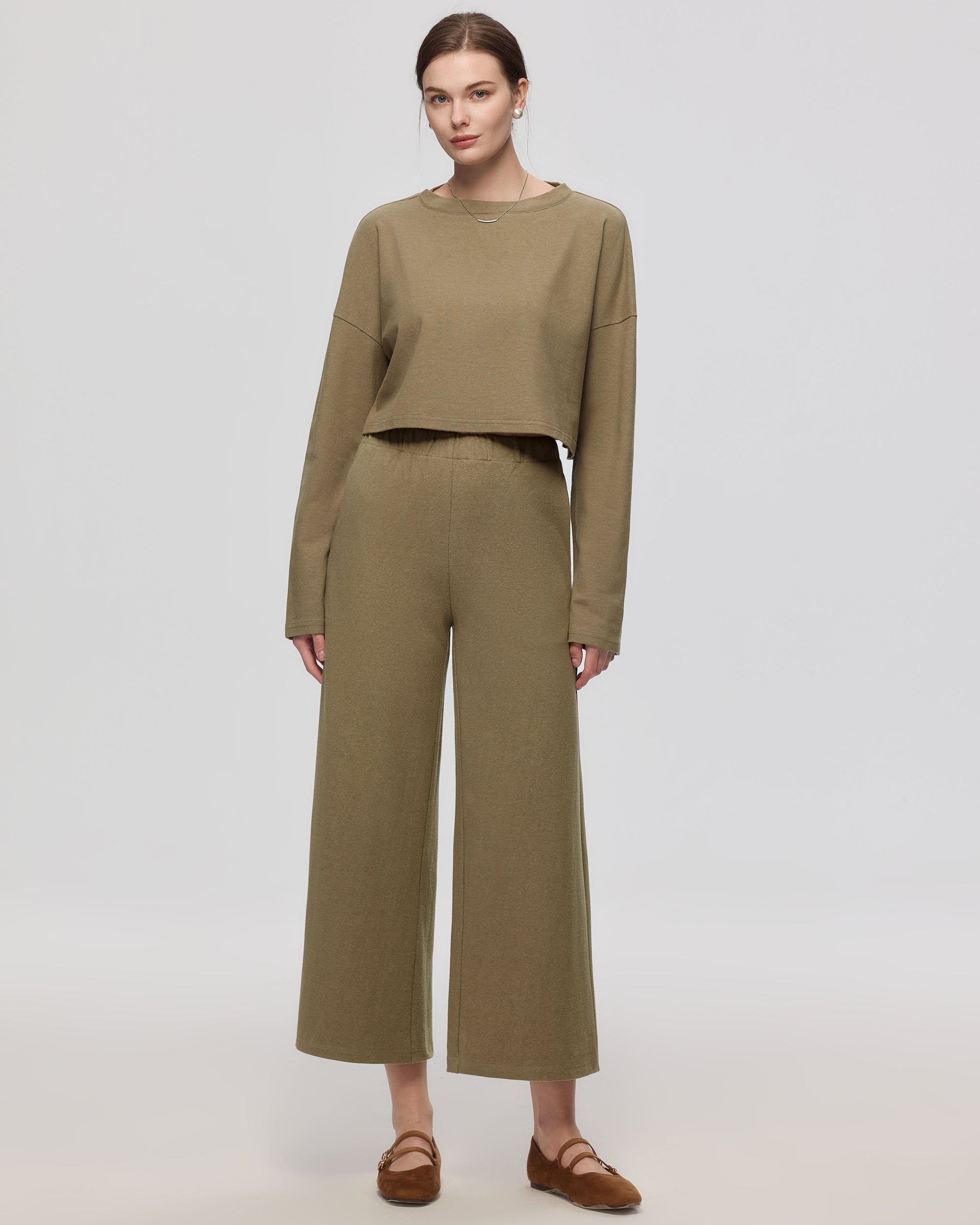 Model wearing Juana Aera Pull-on Pants in olive (hemp–organic cotton blend), showing relaxed wide leg and easy mid-rise fit.
