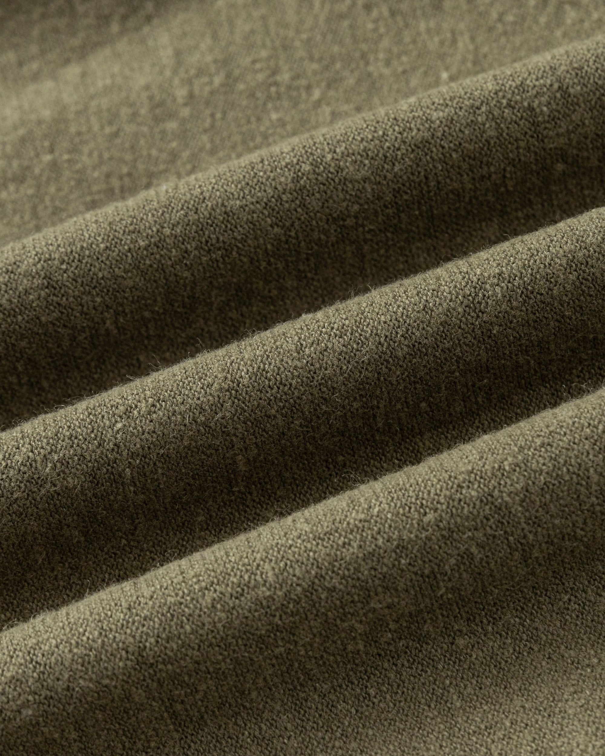 Close-up of Juana Aera Pull-on Pants fabric in olive (hemp–organic cotton blend), showing breathable weave and natural texture.