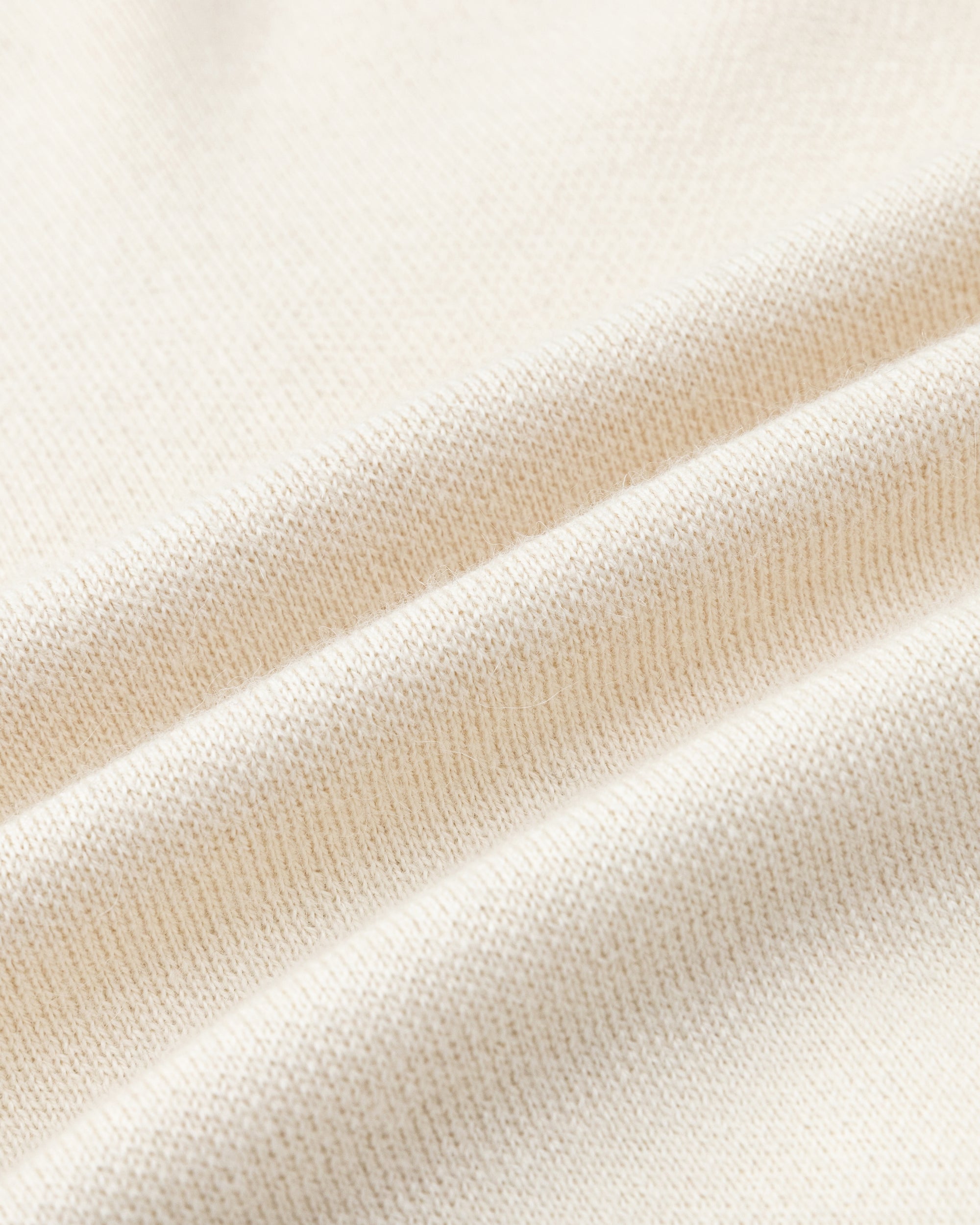 Juana Alpaca Crewneck Sweater in Cream/Black (baby alpaca wool–knit) shown close up with an ultra-soft sweater texture.