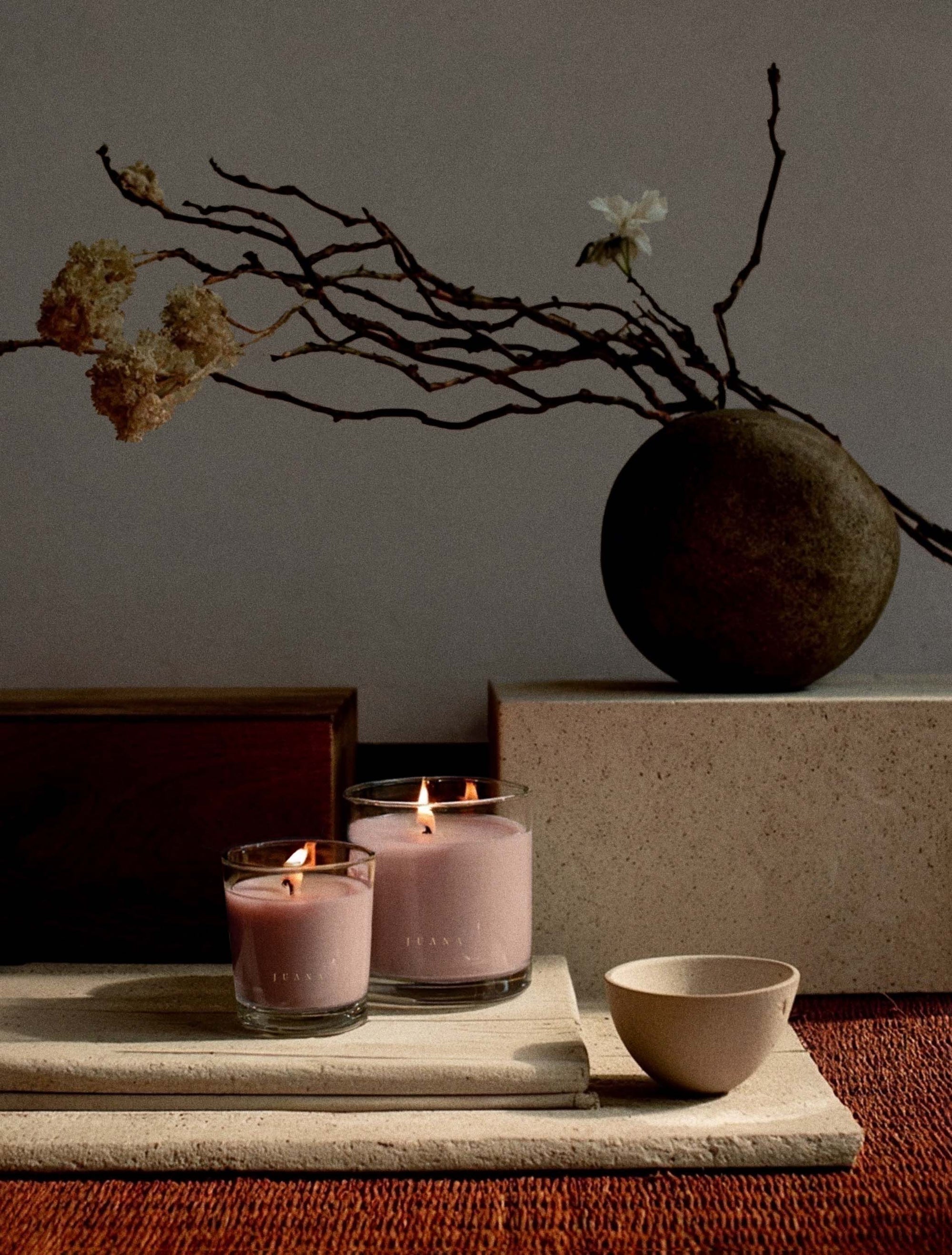 Juana Rose+Jasmine Romance Arouse apothecary candles in two sizes on decorated table, vegan and eco-friendly.