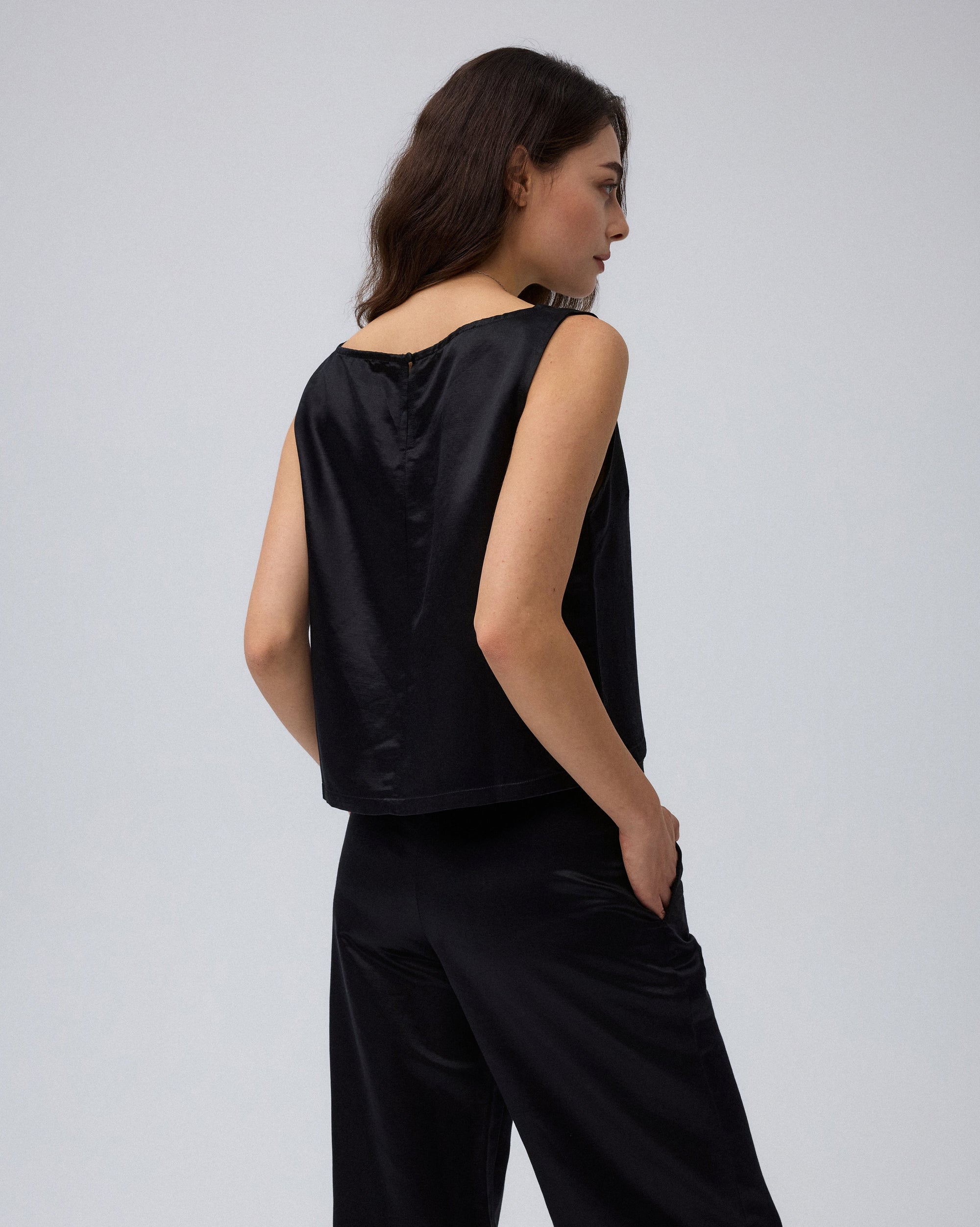 Juana Aven Silk Tank in Black (hemp–silk) shown from the back with a keyhole and covered button closure
