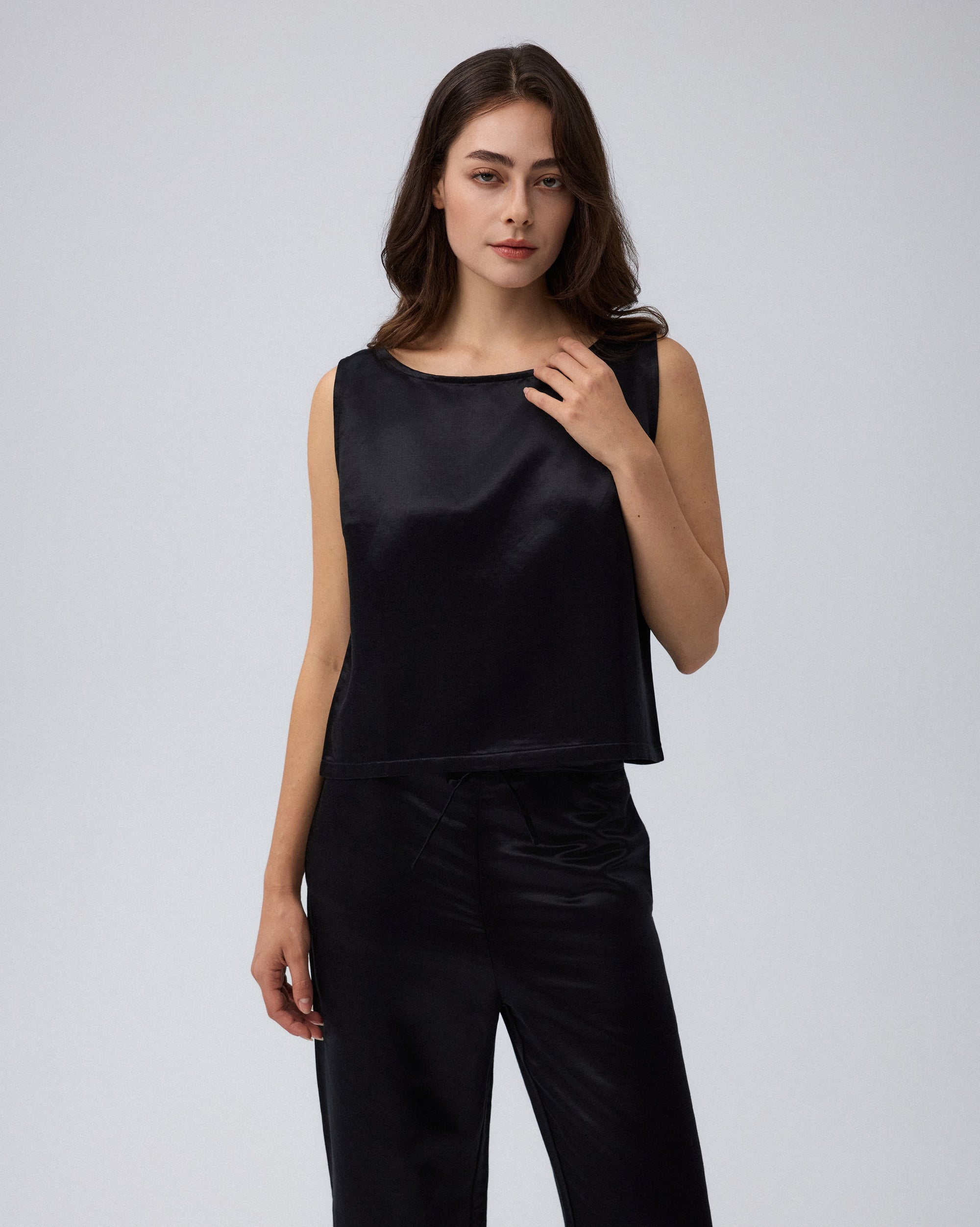 Juana Aven Silk Tank in Black (hemp–silk) worn at an angle to show the sleeveless shape and armhole line
