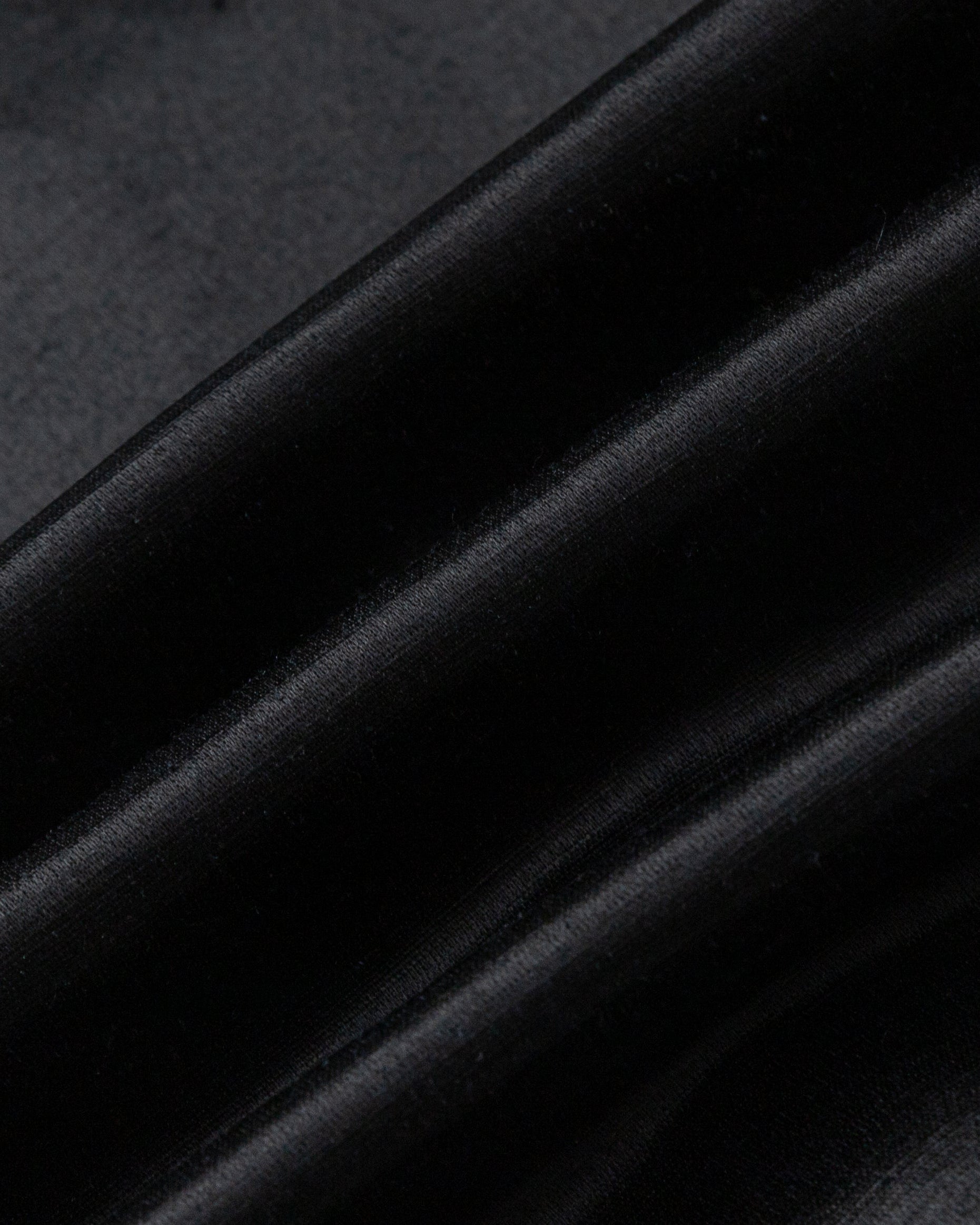 Juana Aven Silk Tank in Black (hemp–silk) showing the smooth woven texture and subtle luster
