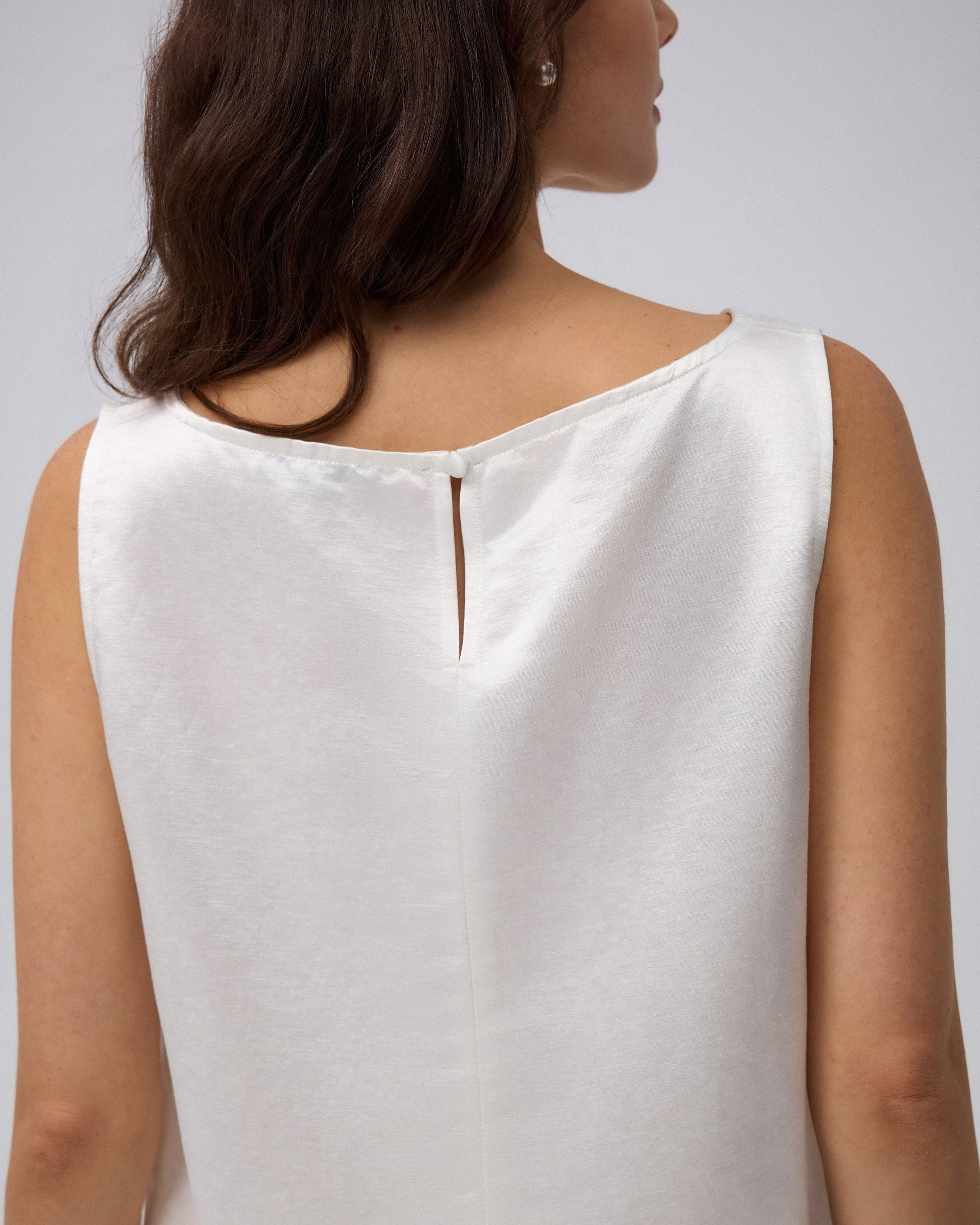 Juana Aven Silk Tank in Pearl White (hemp–silk) shown from the back with a keyhole and covered button closure