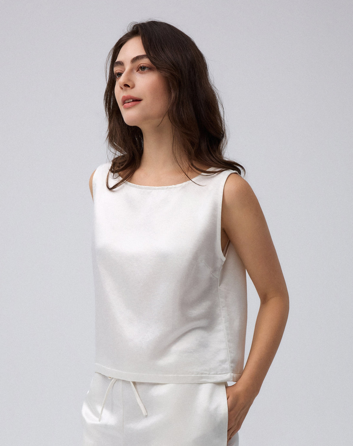 Juana Aven Silk Tank in Pearl White (hemp–silk) worn at an angle to show the sleeveless shape and armhole line