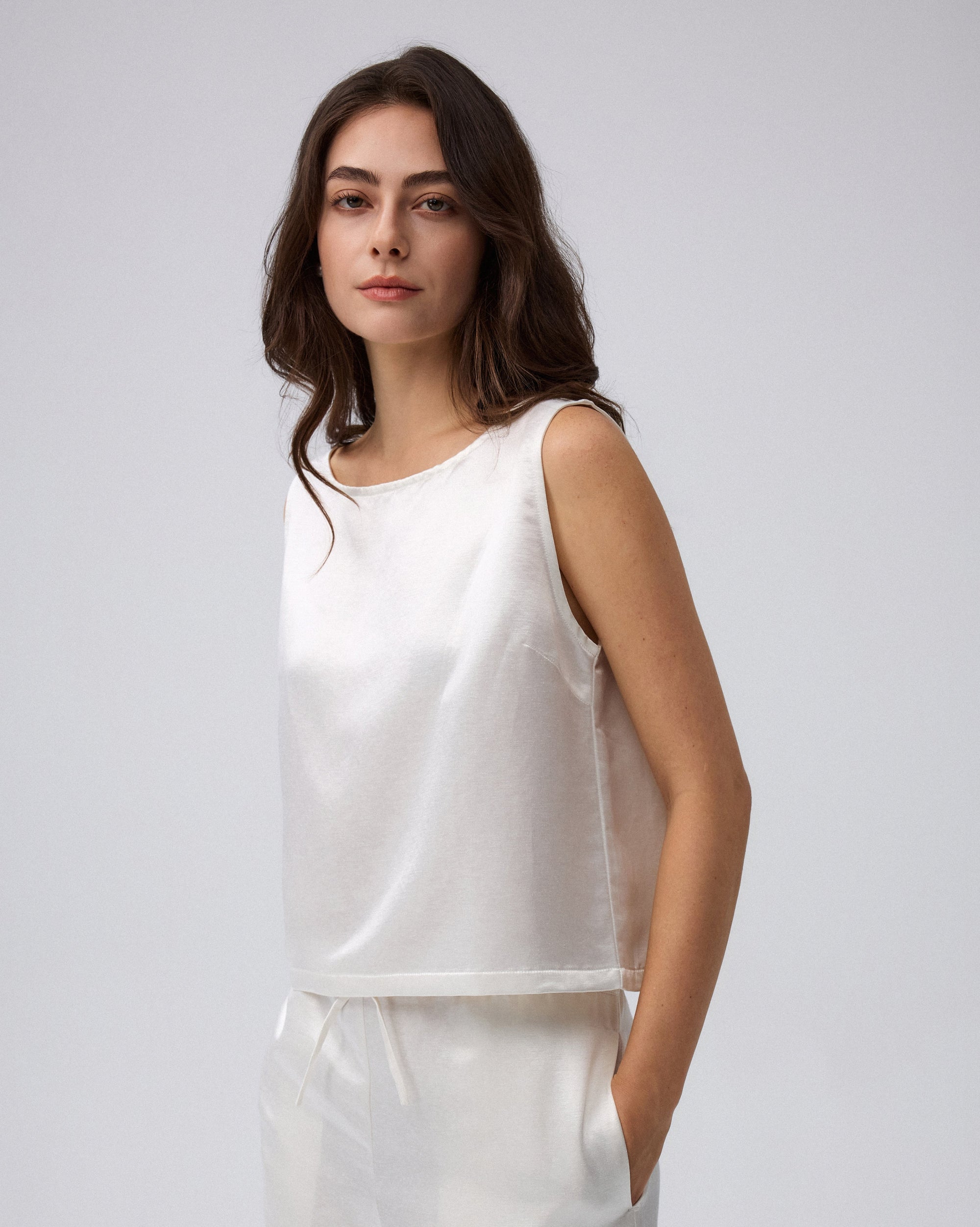 Juana Aven Silk Tank in Pearl White (hemp–silk) shown in profile with a streamlined shell shape