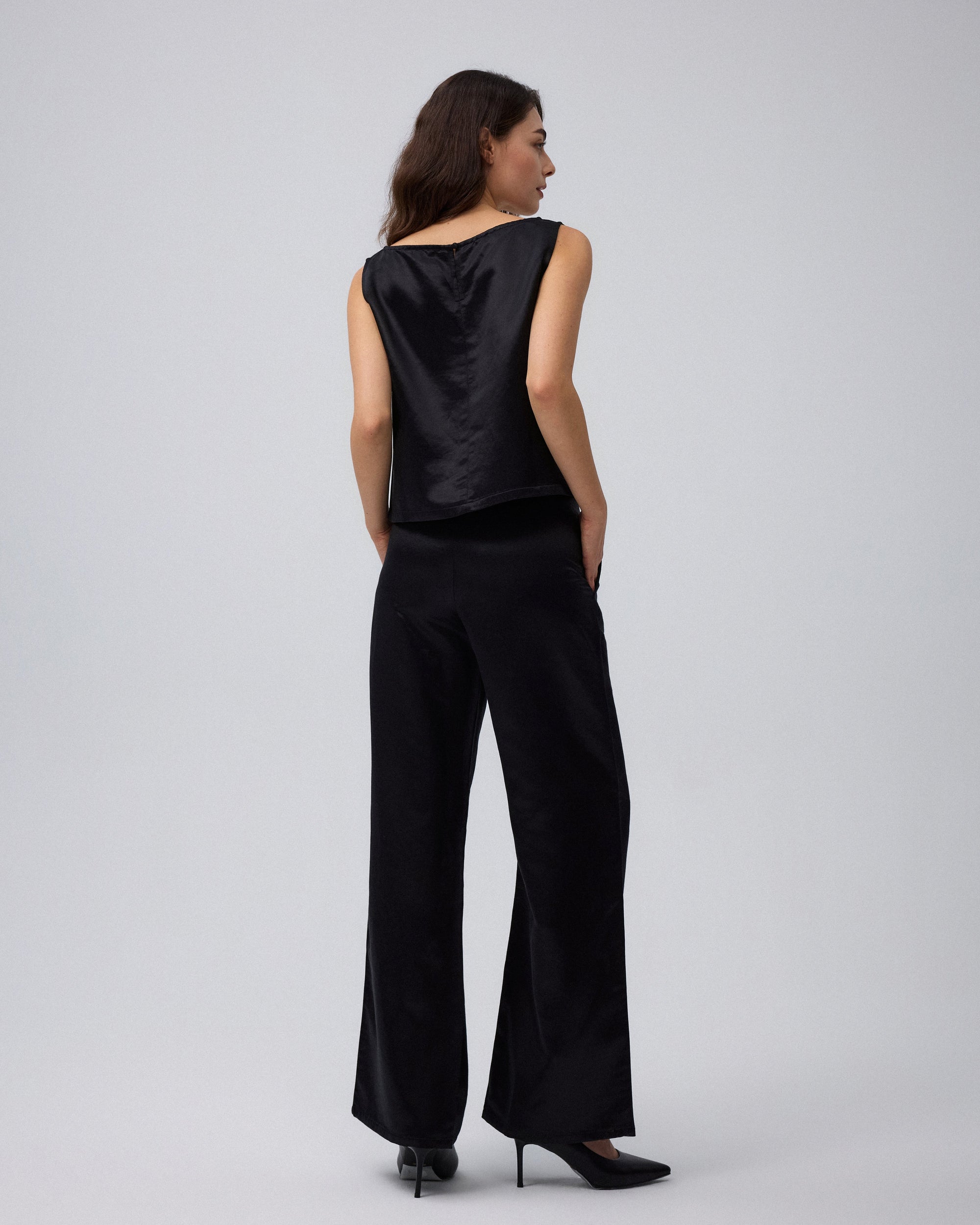 Juana Aven Wide Leg Pants in Black (hemp–silk) modeled from the back to show the clean high-rise waist.
