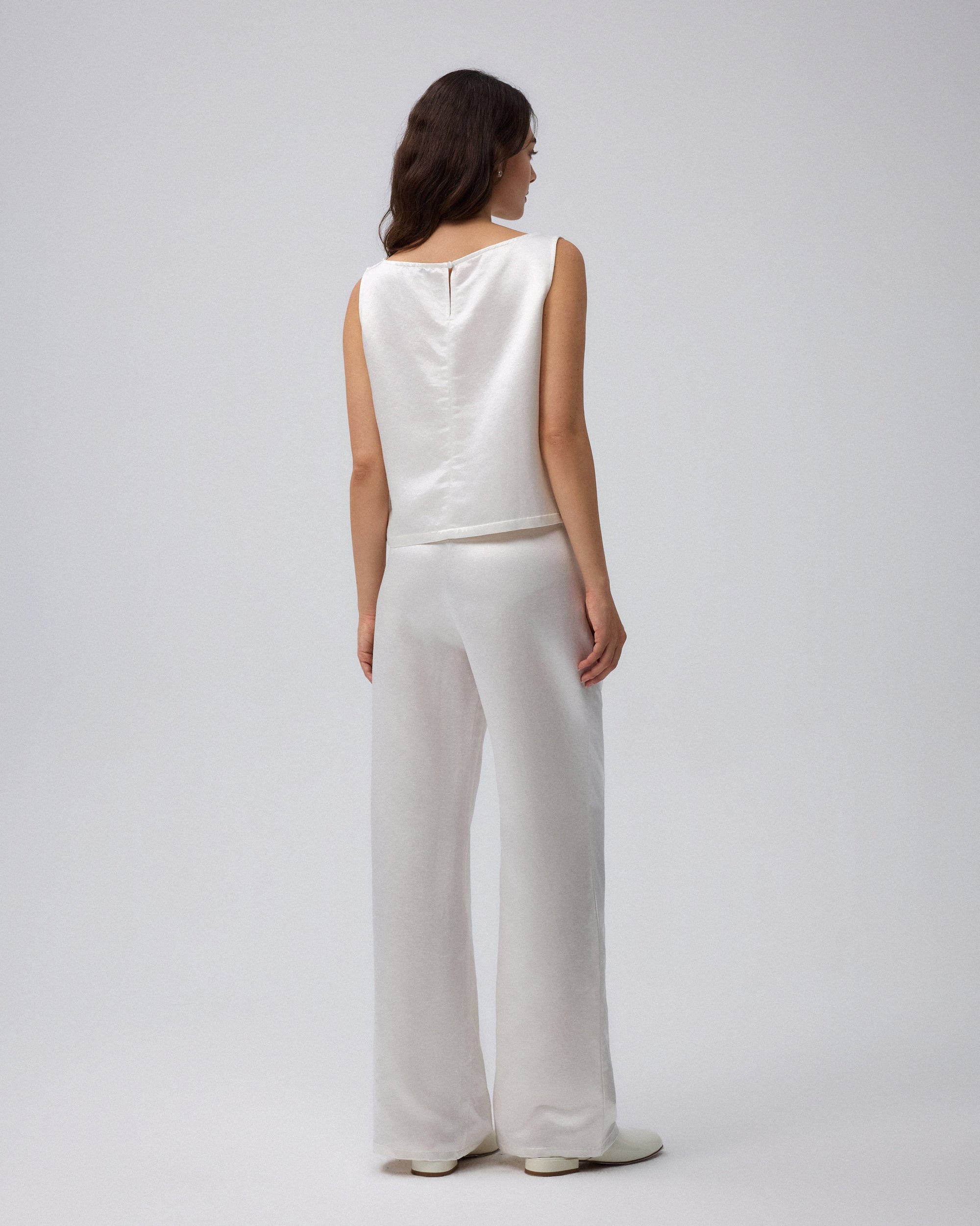 Juana Aven Wide Leg Pants in Pearl White (hemp–silk) modeled from the back to show the clean high-rise waist.
