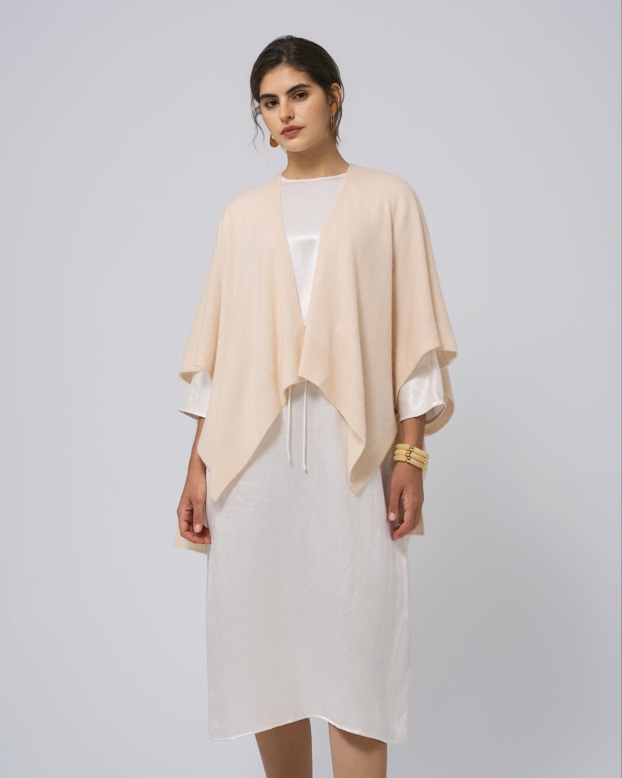 Full-body view of Juana Cashmere Cape in almond milk over silk dress; timeless, minimalist layering piece.