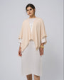 Full-body view of Juana Cashmere Cape in almond milk over silk dress; timeless, minimalist layering piece.