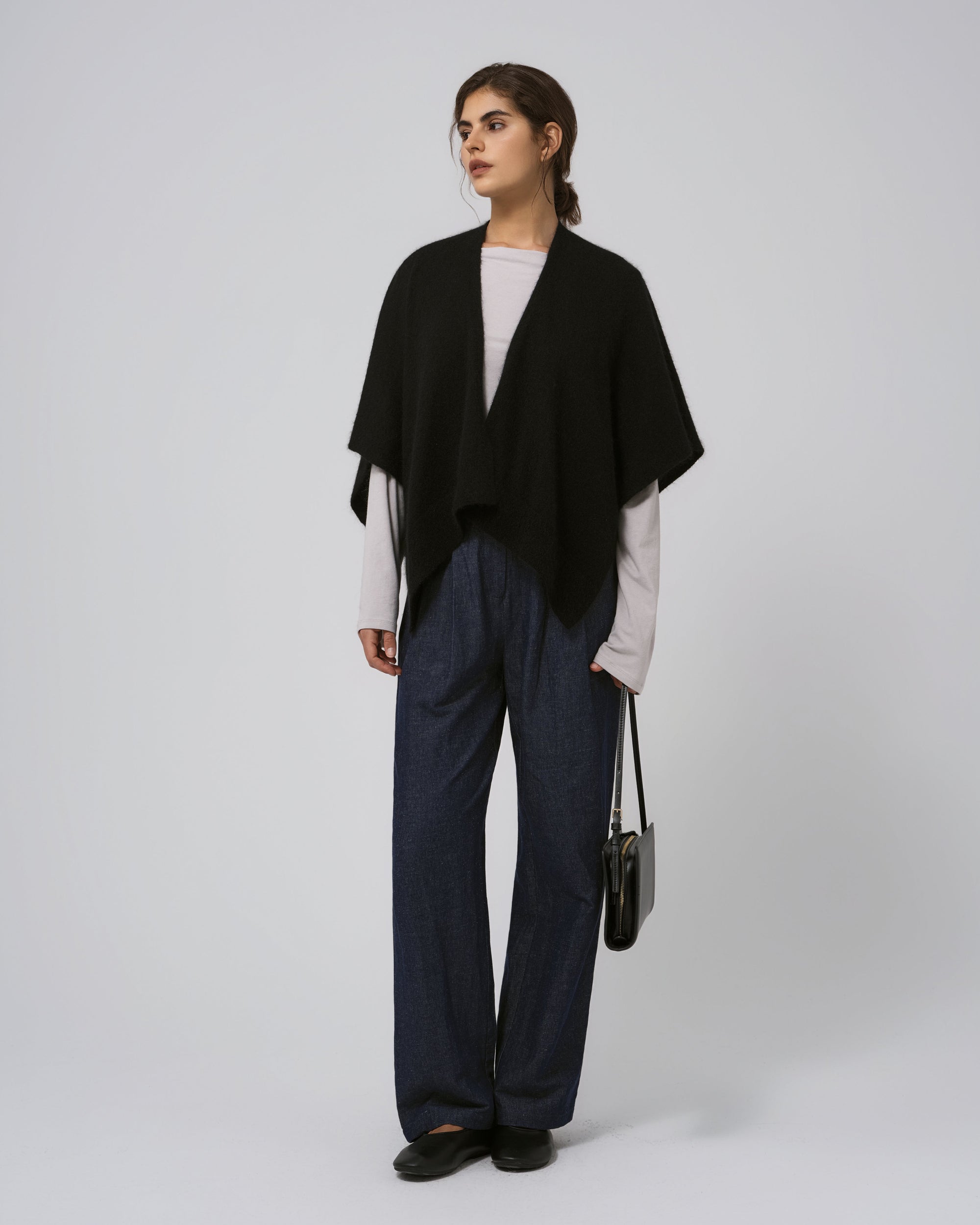 Full-body view of Juana Cashmere Cape in black; timeless, minimalist layering piece.