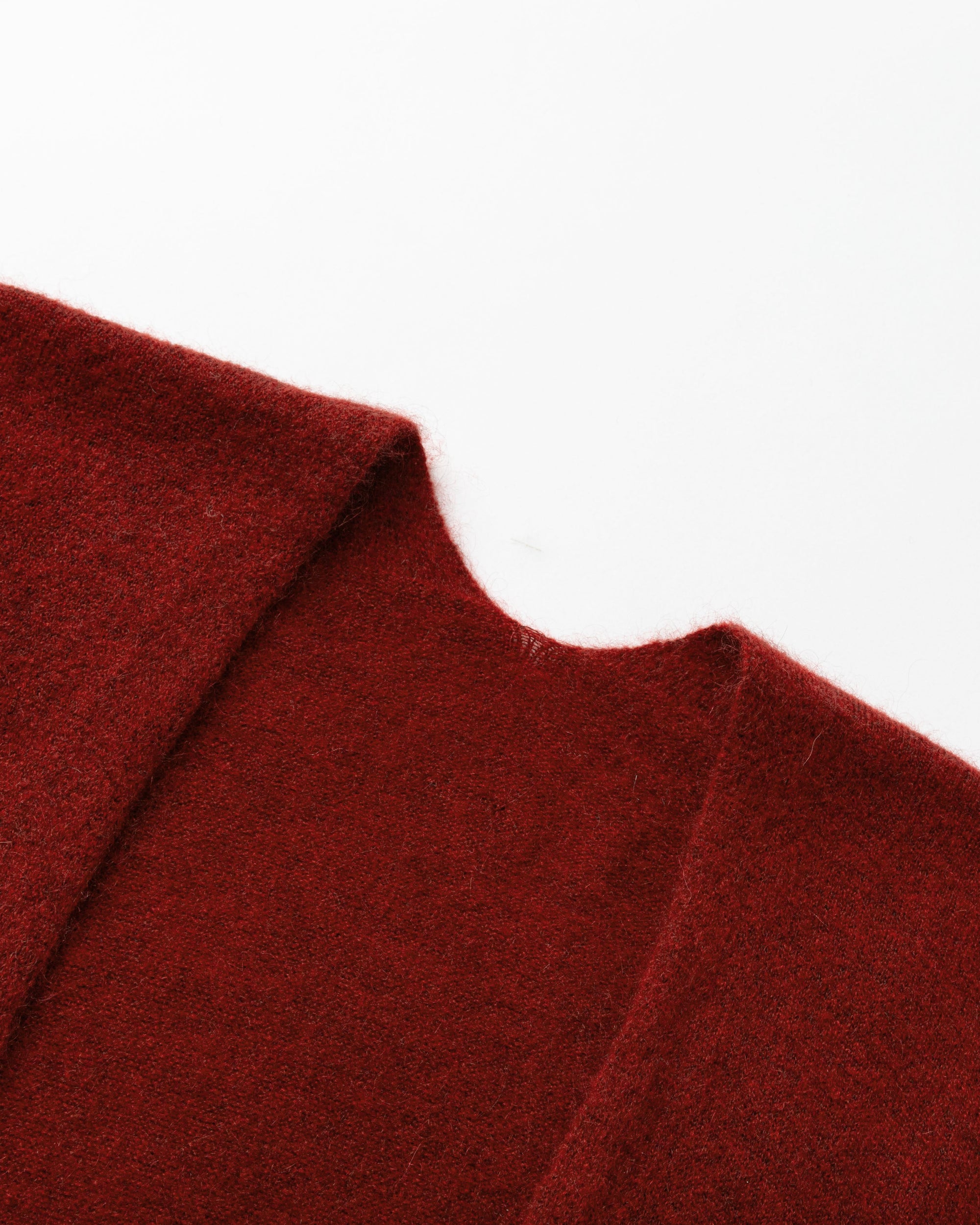 Detail of neckline and edge finish on burgundy wool–cashmere–hemp cape.