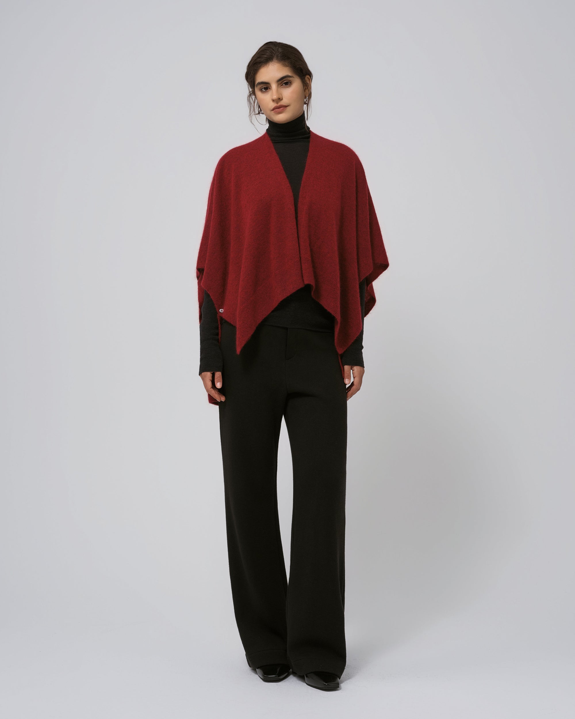 Full-body view of Juana Cashmere Cape in burgundy on Black Ossa Turtleneck; versatile, seasonless layer.