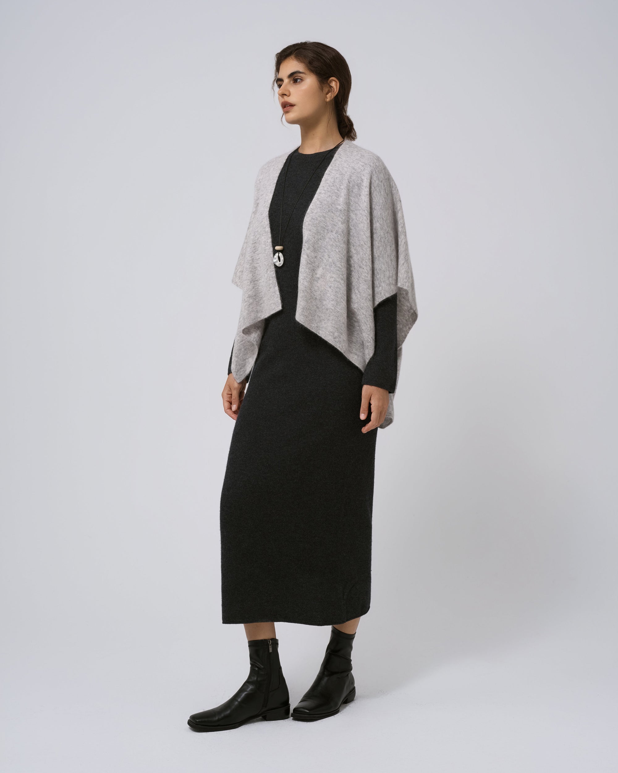 Full-body view of Juana Cashmere Cape in light grey over black dress; timeless layering piece.