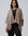 Detail shot of edge finish and knit texture on Juana Cashmere Cape (oatmeal), emphasizing quality and drape.