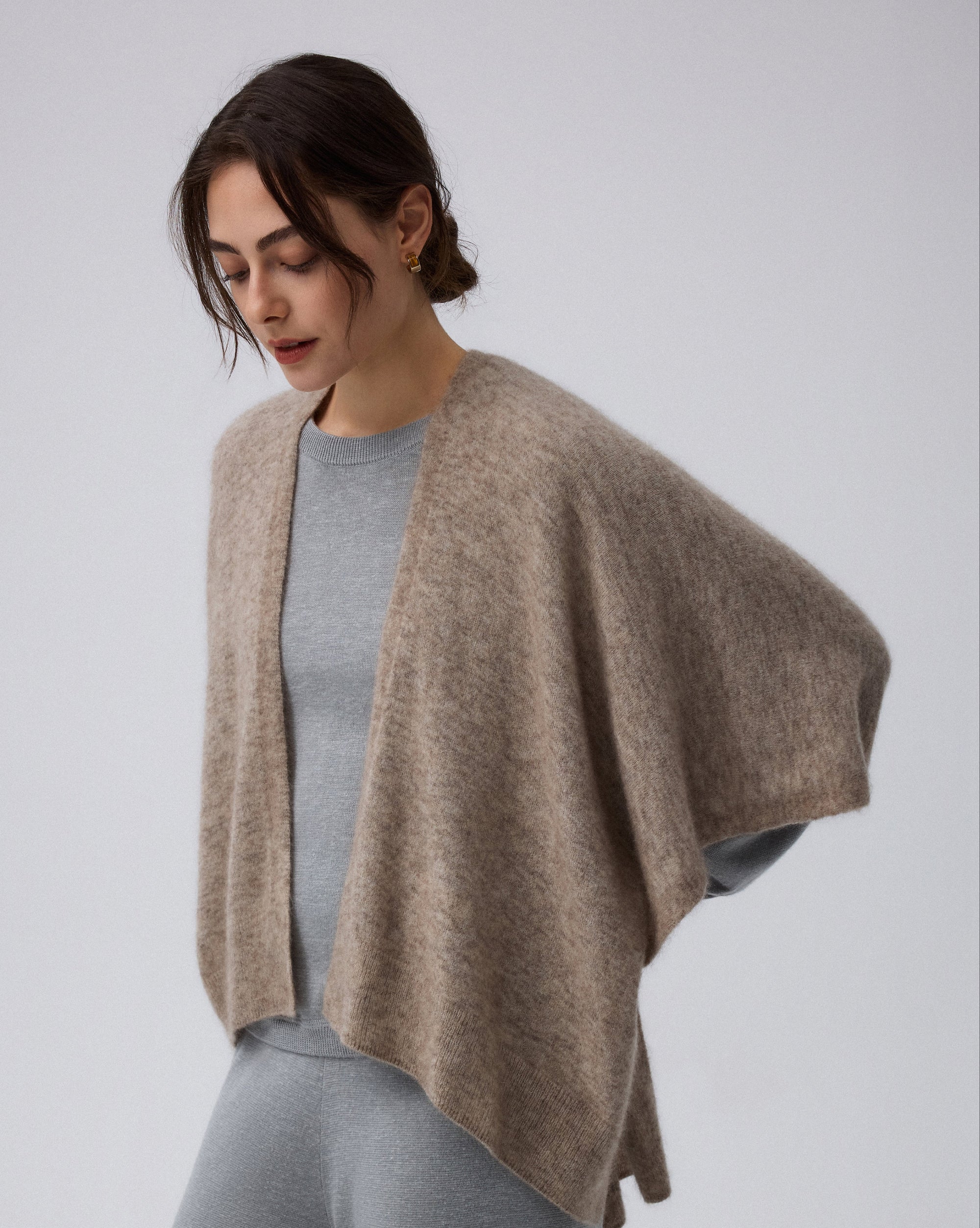 Model styling Juana Cashmere Cape (oatmeal) over the Nilo Knitted Crewneck and Nilo Knitted Pull-on Pants (heather gray)