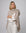 Woman wearing Juana Cashmere Cape in oatmeal wool–cashmere–hemp knit, showing fluid, sculptural drape.