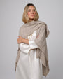 Woman wearing Juana Cashmere Cape in oatmeal wool–cashmere–hemp knit, showing fluid, sculptural drape.