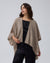 Detail shot of edge finish and knit texture on Juana Cashmere Cape (oatmeal), emphasizing quality.