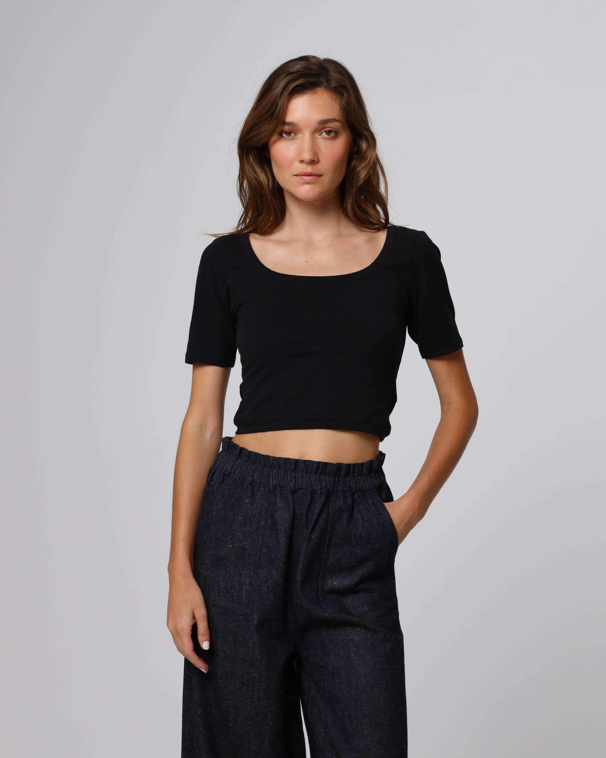 Woman wearing Juana Classic Square Neck T-Shirt in a hemp–organic cotton blend (black), styled for sustainable everyday wear.