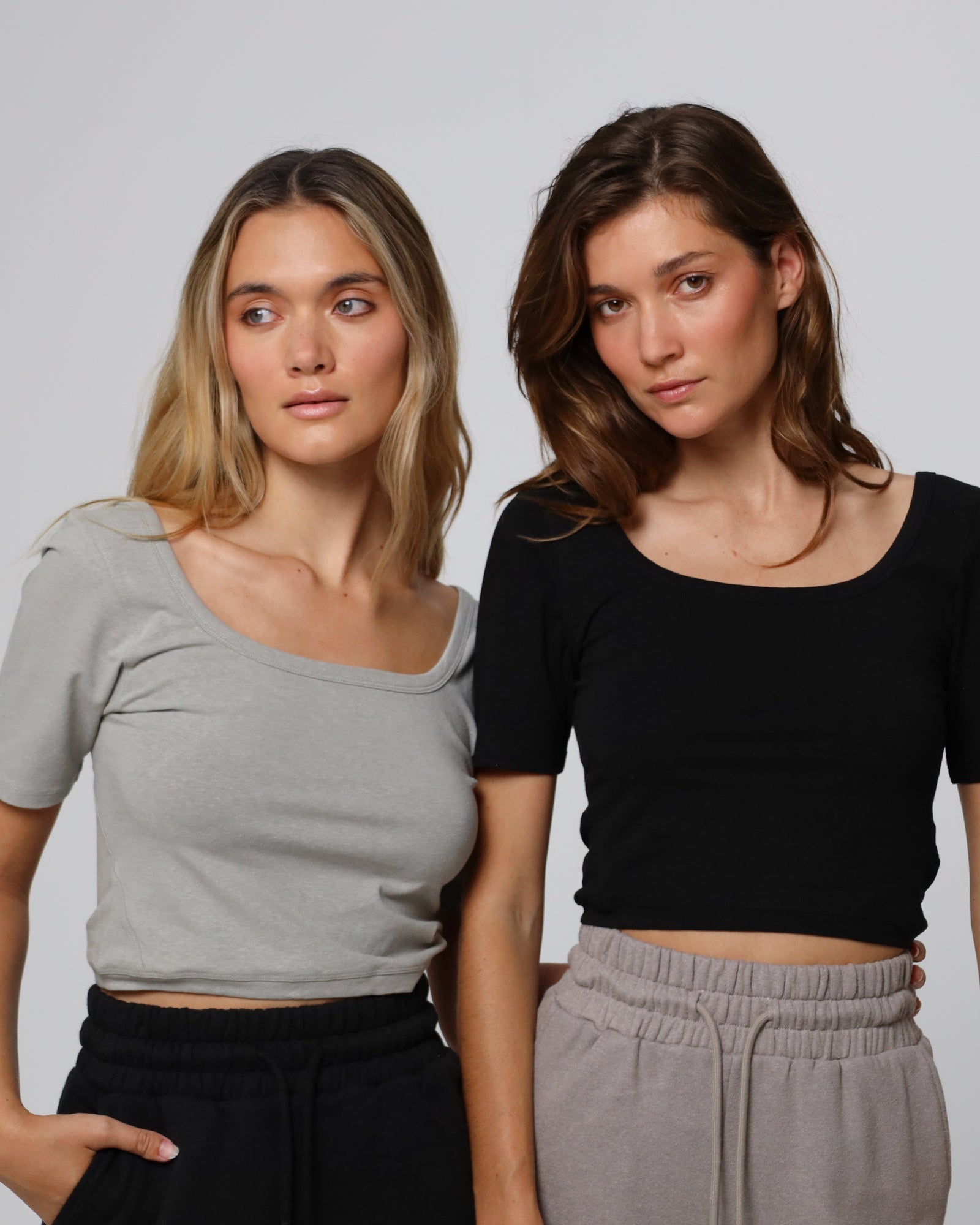 Two models styling Classic Square Neck T-Shirt (gray and black) with tailored joggers for a relaxed, eco-friendly look.