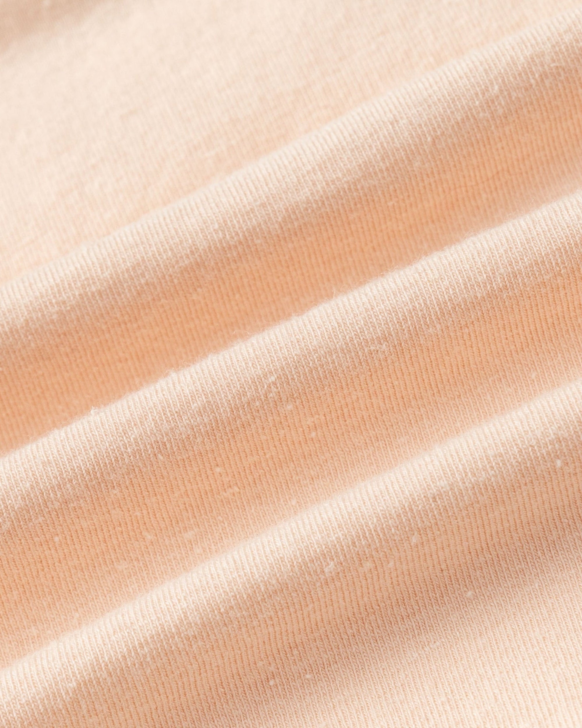 Close-up of hemp–organic cotton–spandex knit of Classic Square Neck T-Shirt (peach), highlighting breathable texture.