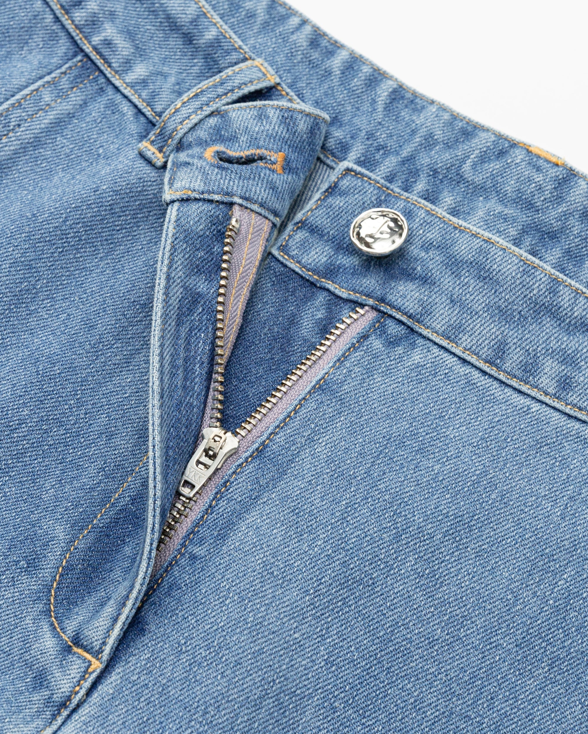 Juana Denim Atelier Flare Jeans light blue denim (cotton–hemp blend) detail layflat showing zipper, button, clean waistband, and streamlined finish