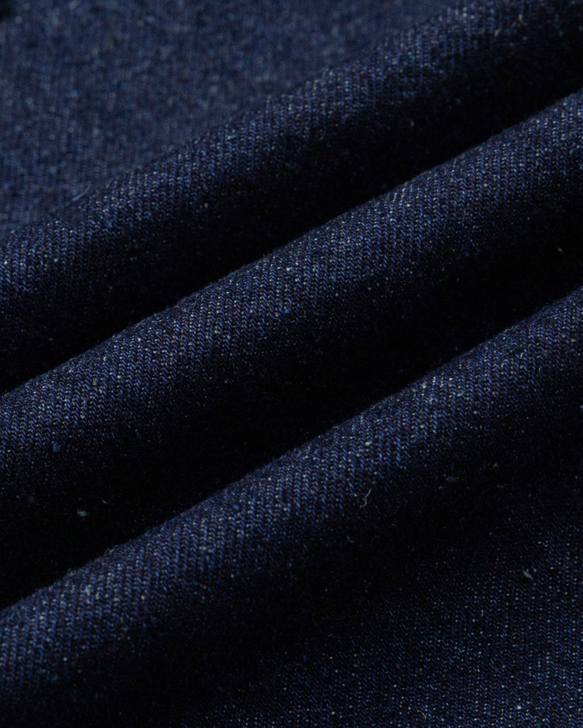 Close-up of hemp–organic cotton denim fabric of the apron (indigo), highlighting breathable, durable weave.