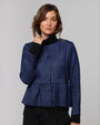 Model wearing Juana Denim Atelier Peplum Jacket in blue denim (pure hemp), showing cinched waist and soft peplum flare.