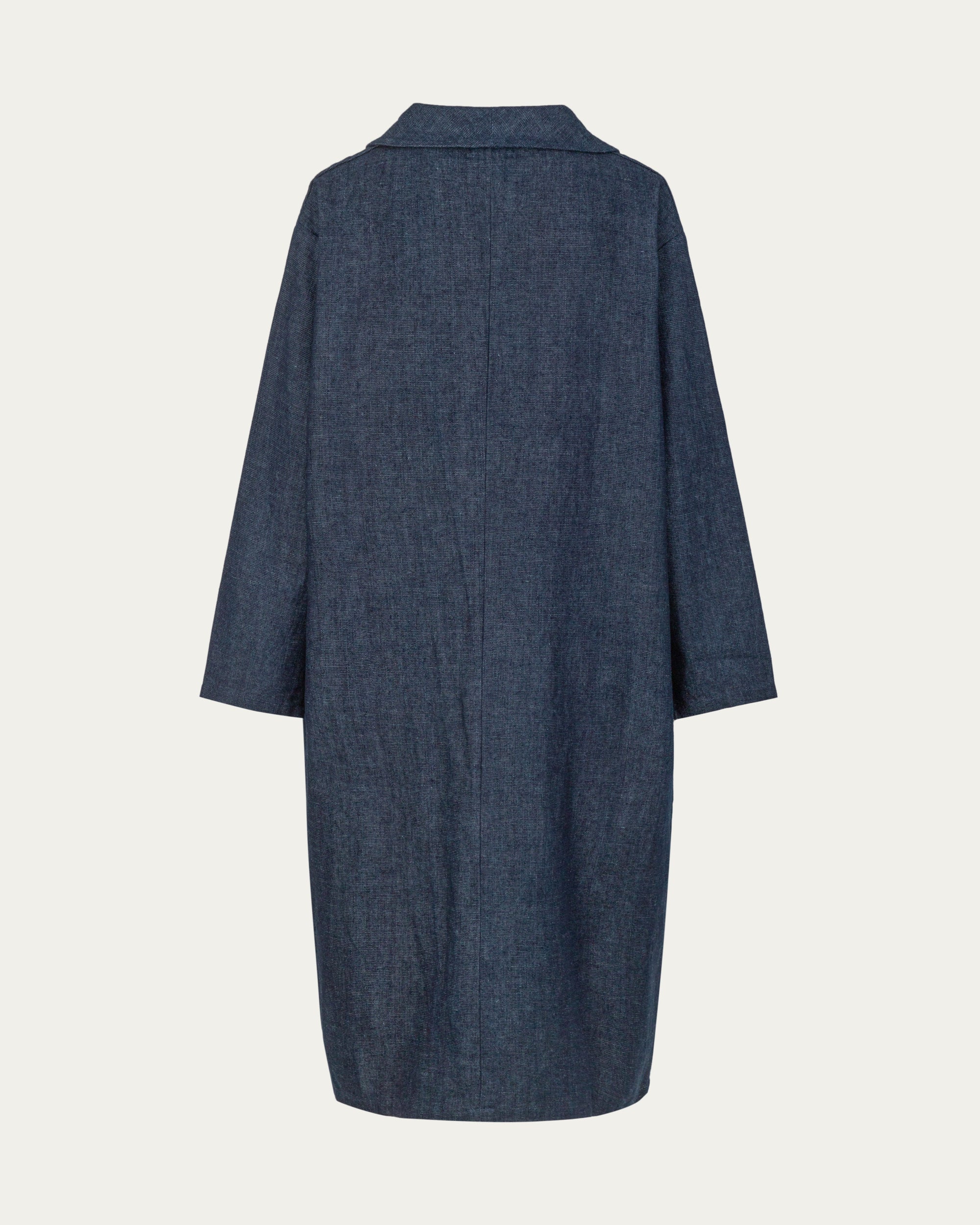 Denim Atelier Trench Coat (indigo denim) on ghost mannequin, back view showing elongated drape and seamwork.