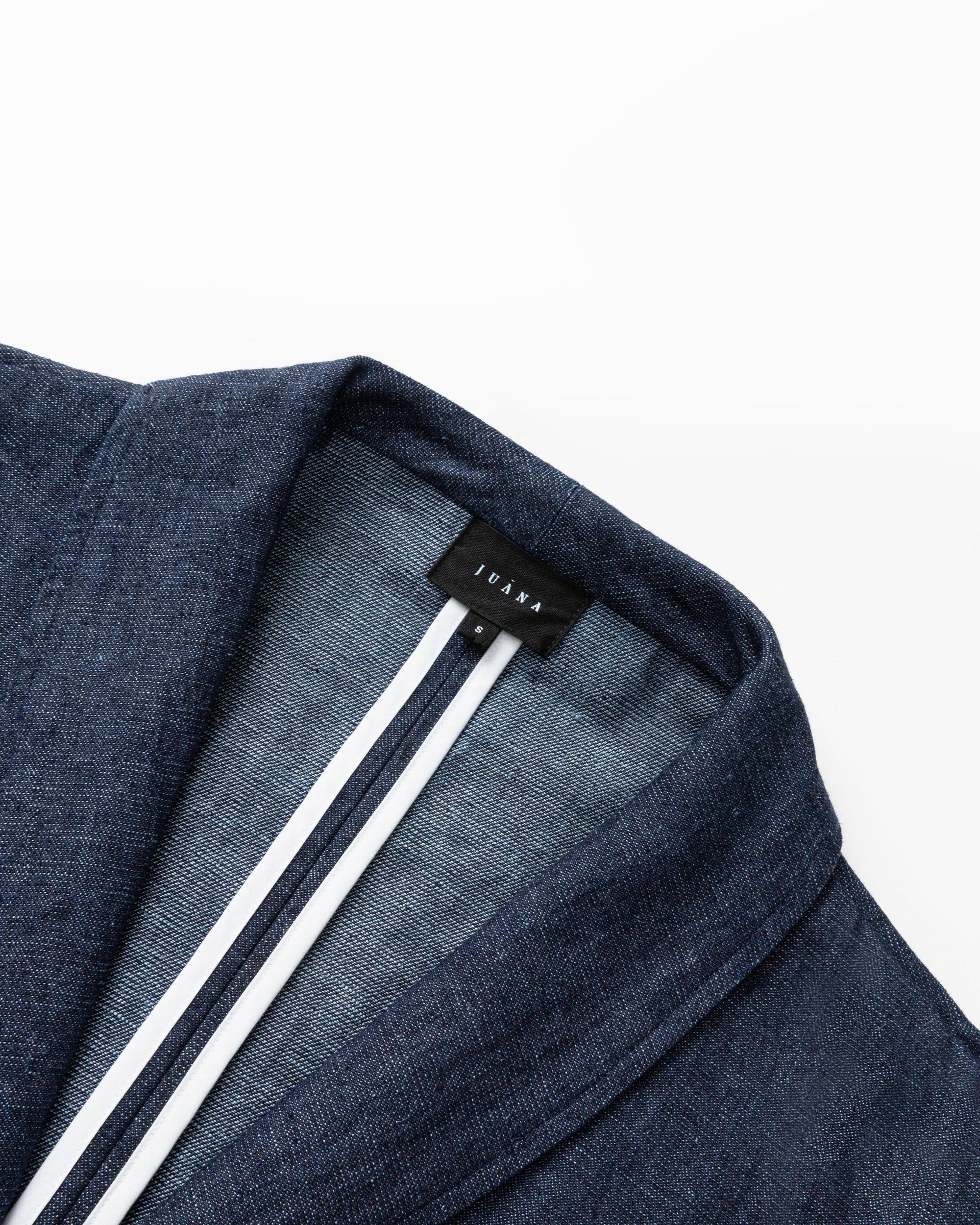 Detail shot of stitching, interior finishing, and trench construction on Denim Atelier Trench Coat (indigo denim).