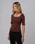 Woman wearing Juana Hemp Essentials Asymmetrical Neckline Tee in cacao hemp–organic cotton stretch blend, styled for sustainable everyday wear.