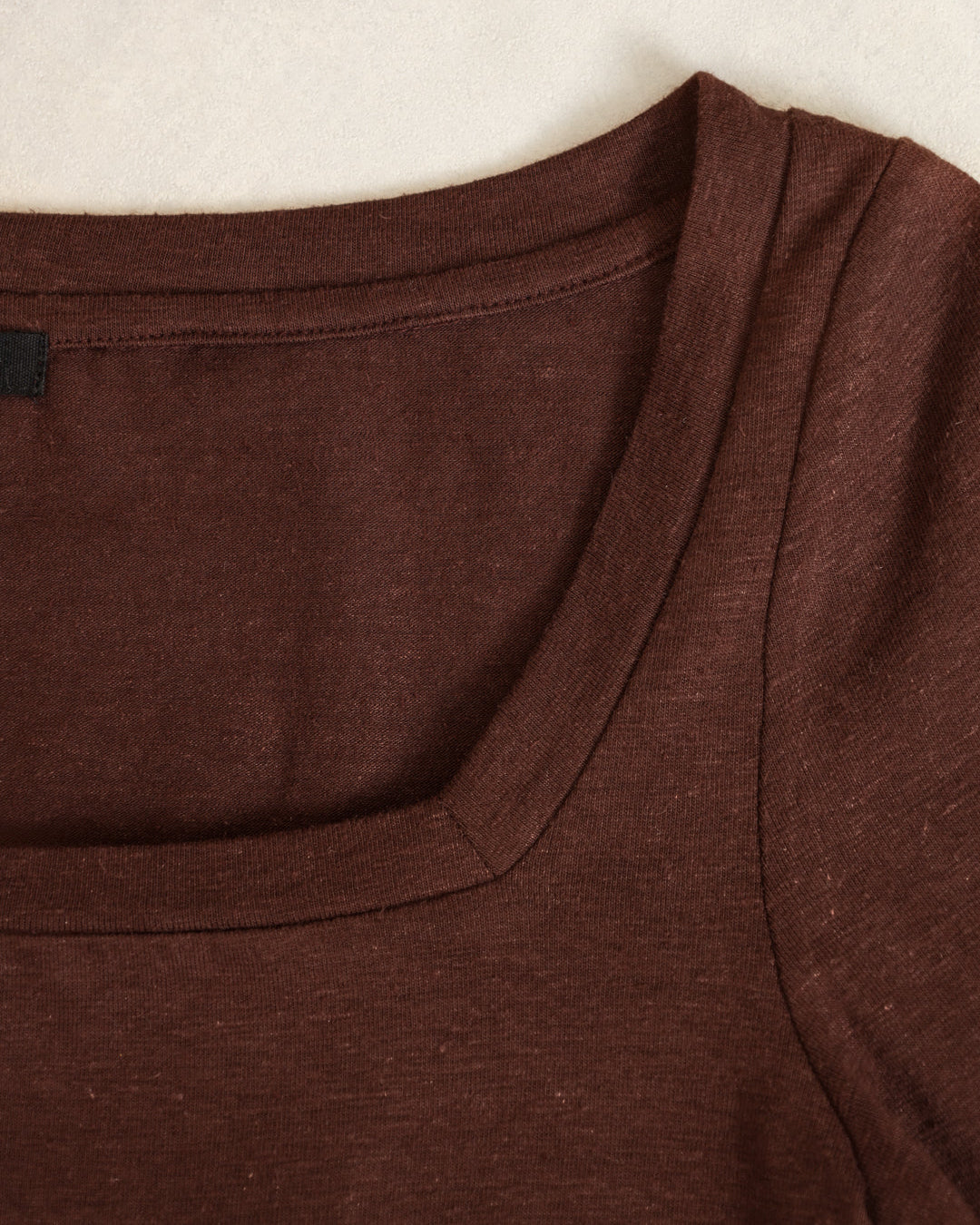 Flat lay of the Asymmetrical Neckline Tee showing clean seams, precise neckline, and sustainable fabric.